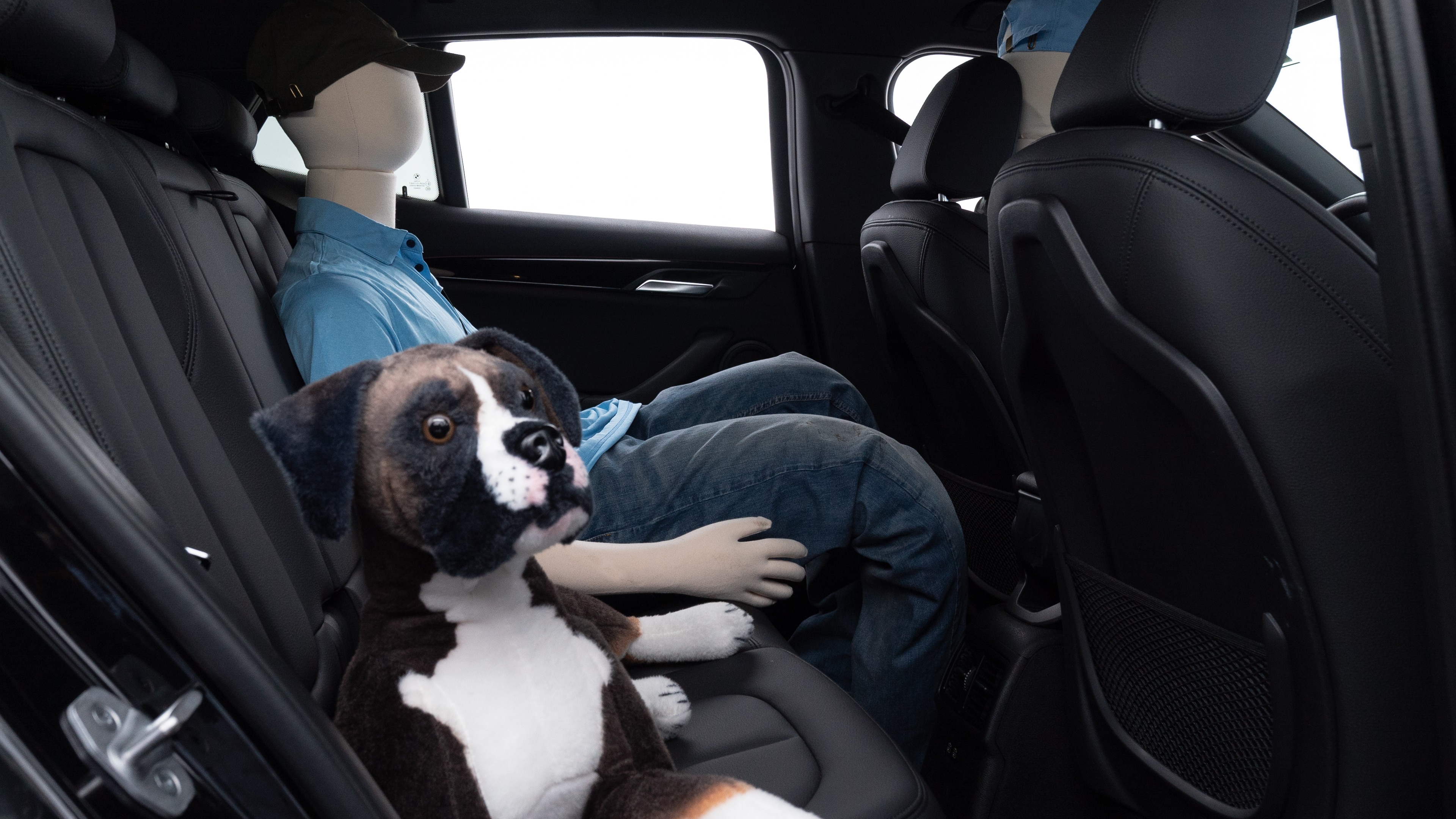A series of second-row backseat photos is shown including one seating a baby seat and one seating a 6'1" mannequin.