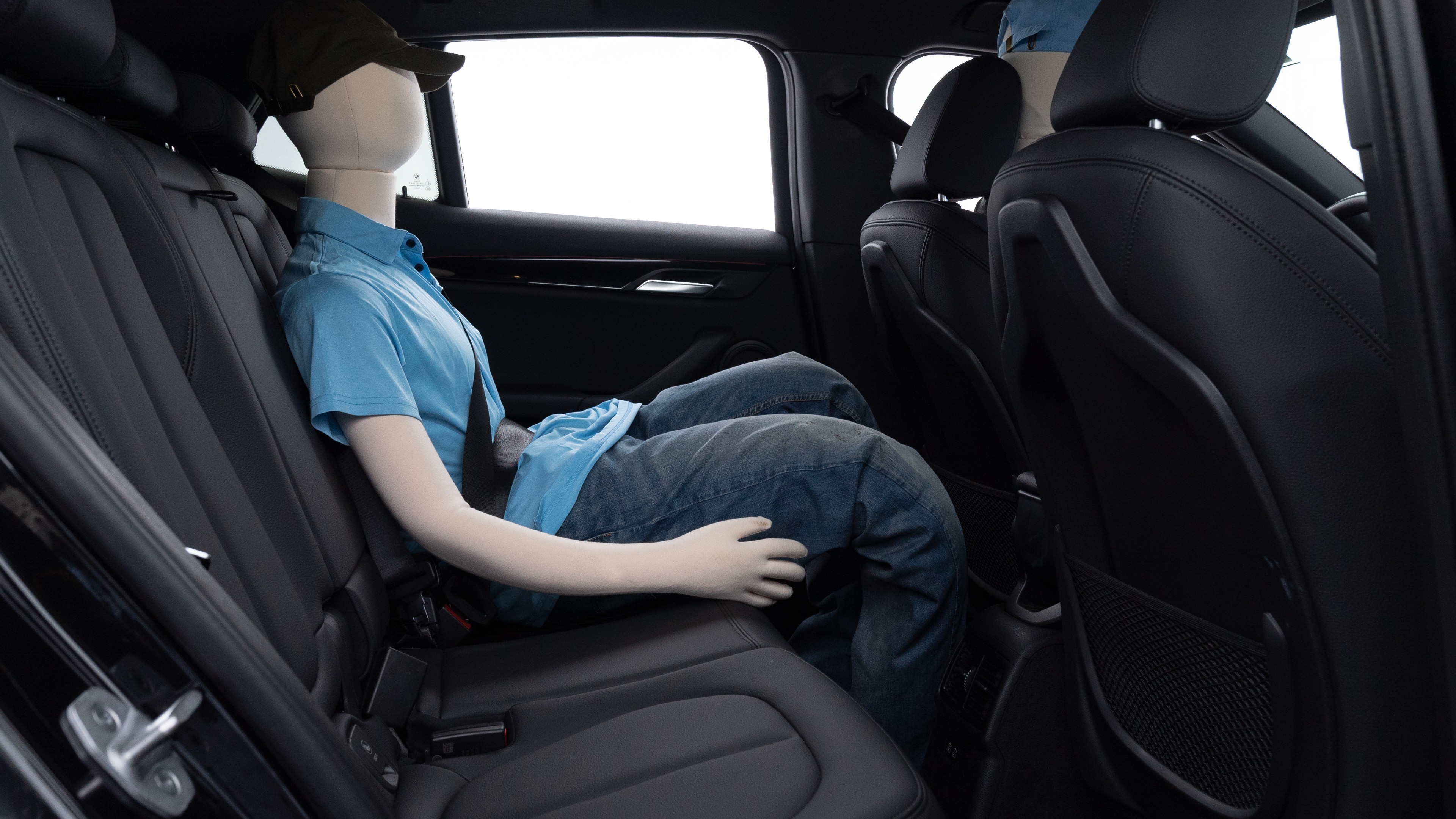 A series of second-row backseat photos is shown including one seating a baby seat and one seating a 6'1" mannequin.