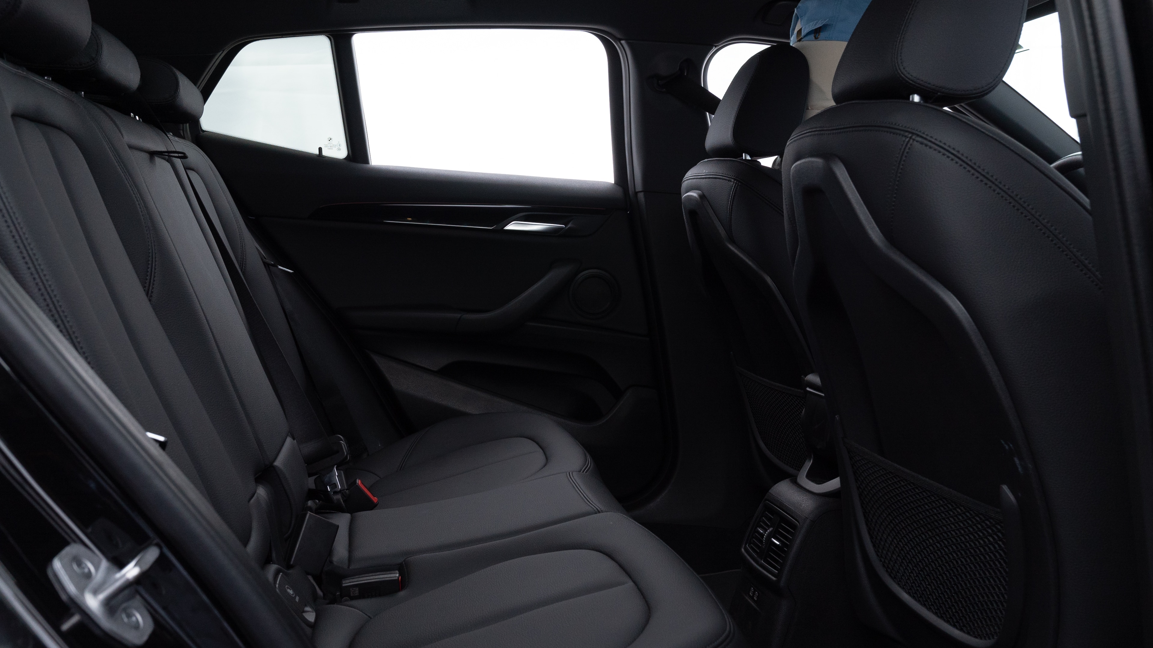 A series of second-row backseat photos is shown including one seating a baby seat and one seating a 6'1" mannequin.