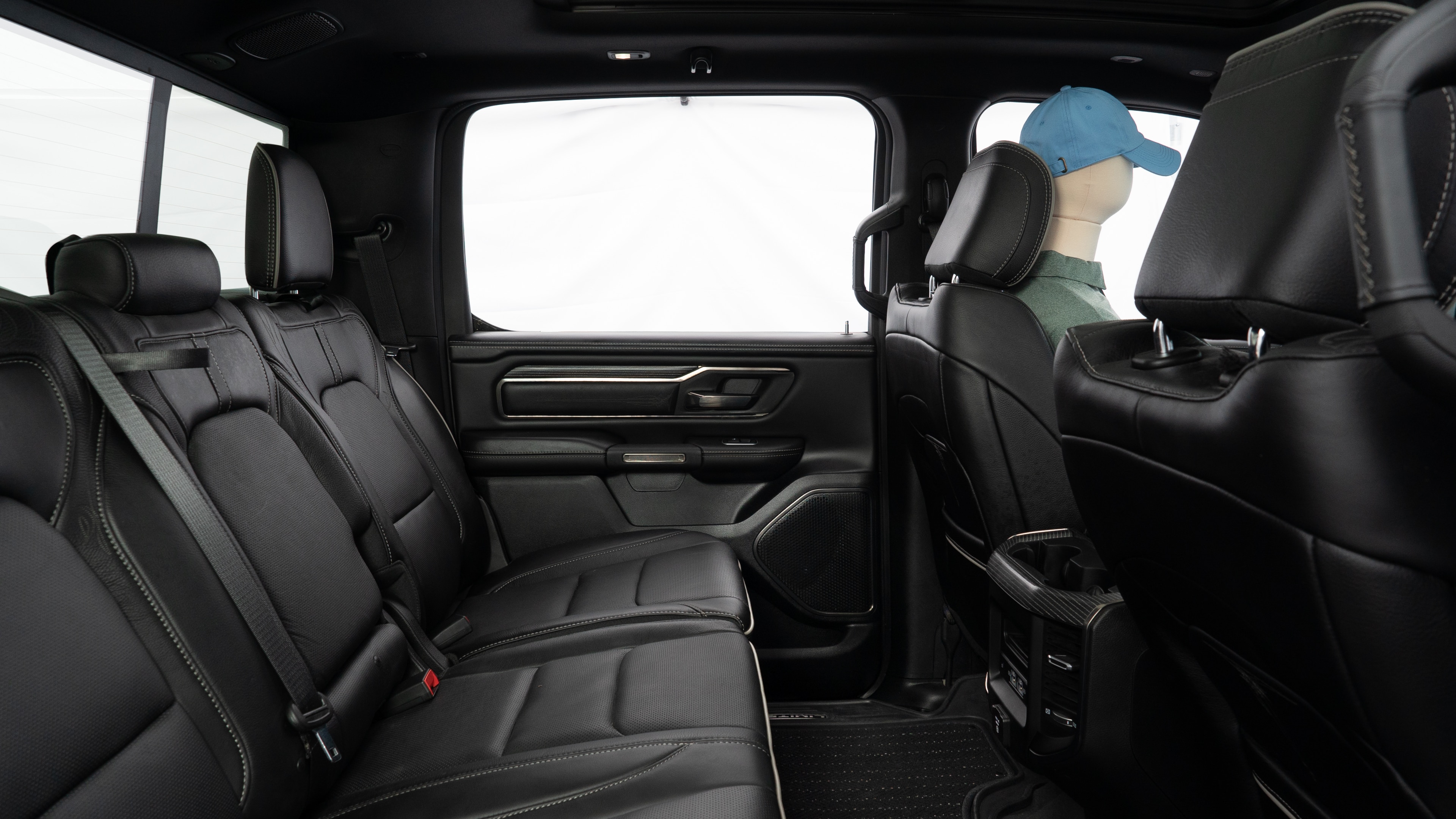 A series of second-row backseat photos is shown including one seating a baby seat and one seating a 6'1" mannequin.