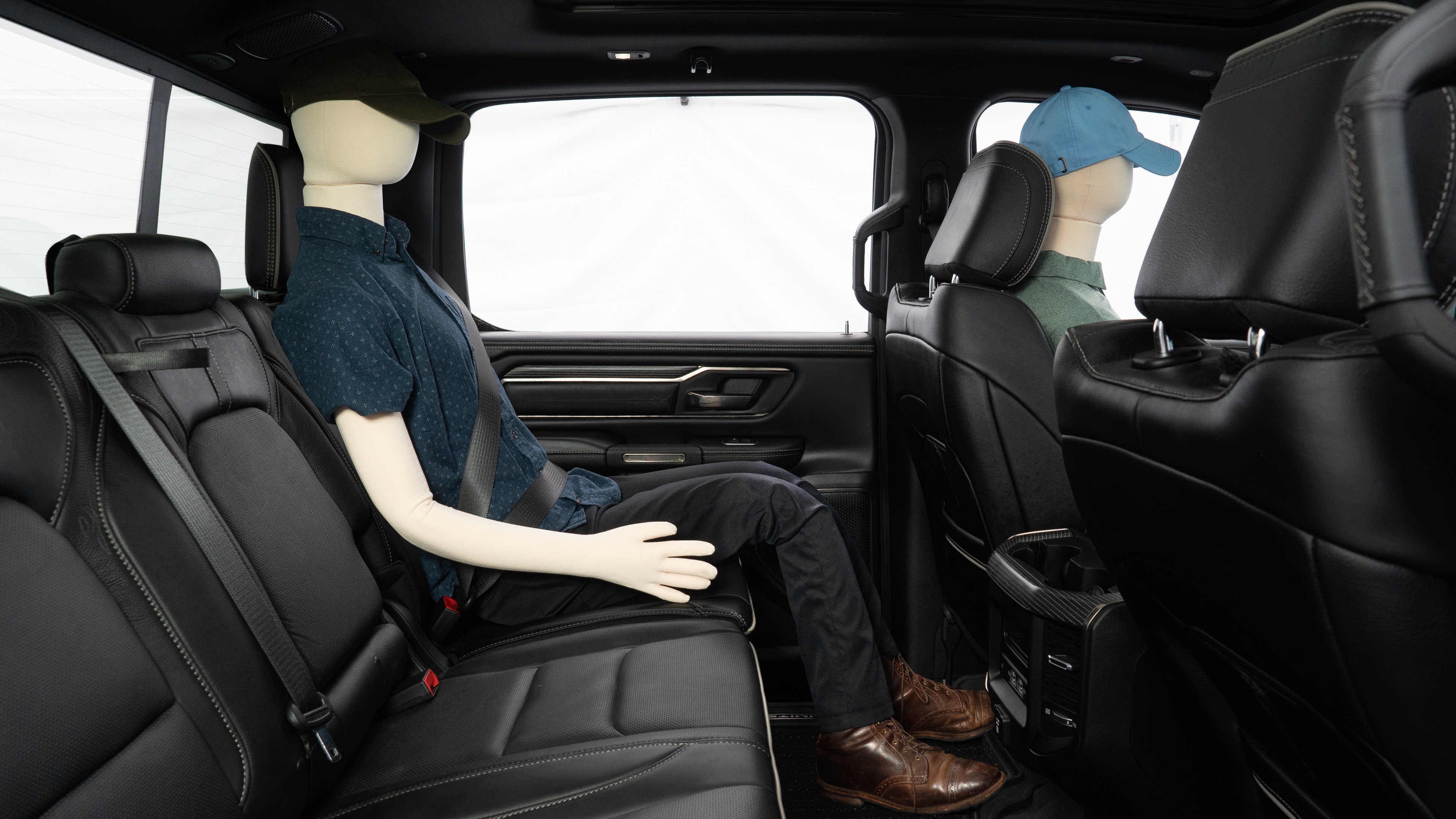 A series of second-row backseat photos is shown including one seating a baby seat and one seating a 6'1" mannequin.