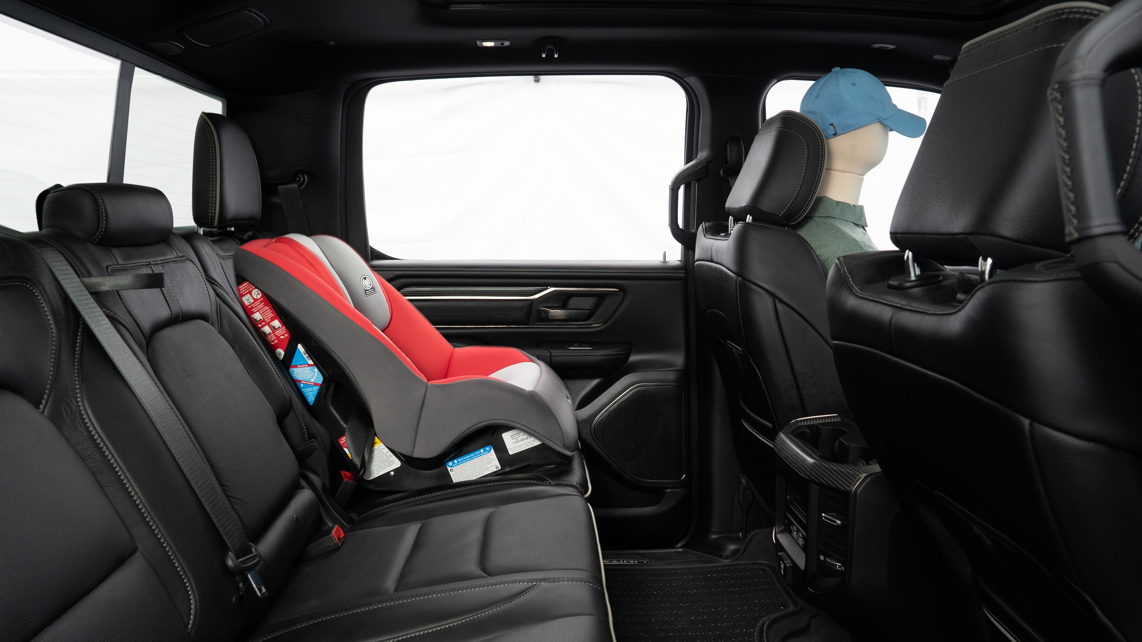 A series of second-row backseat photos is shown including one seating a baby seat and one seating a 6'1" mannequin.