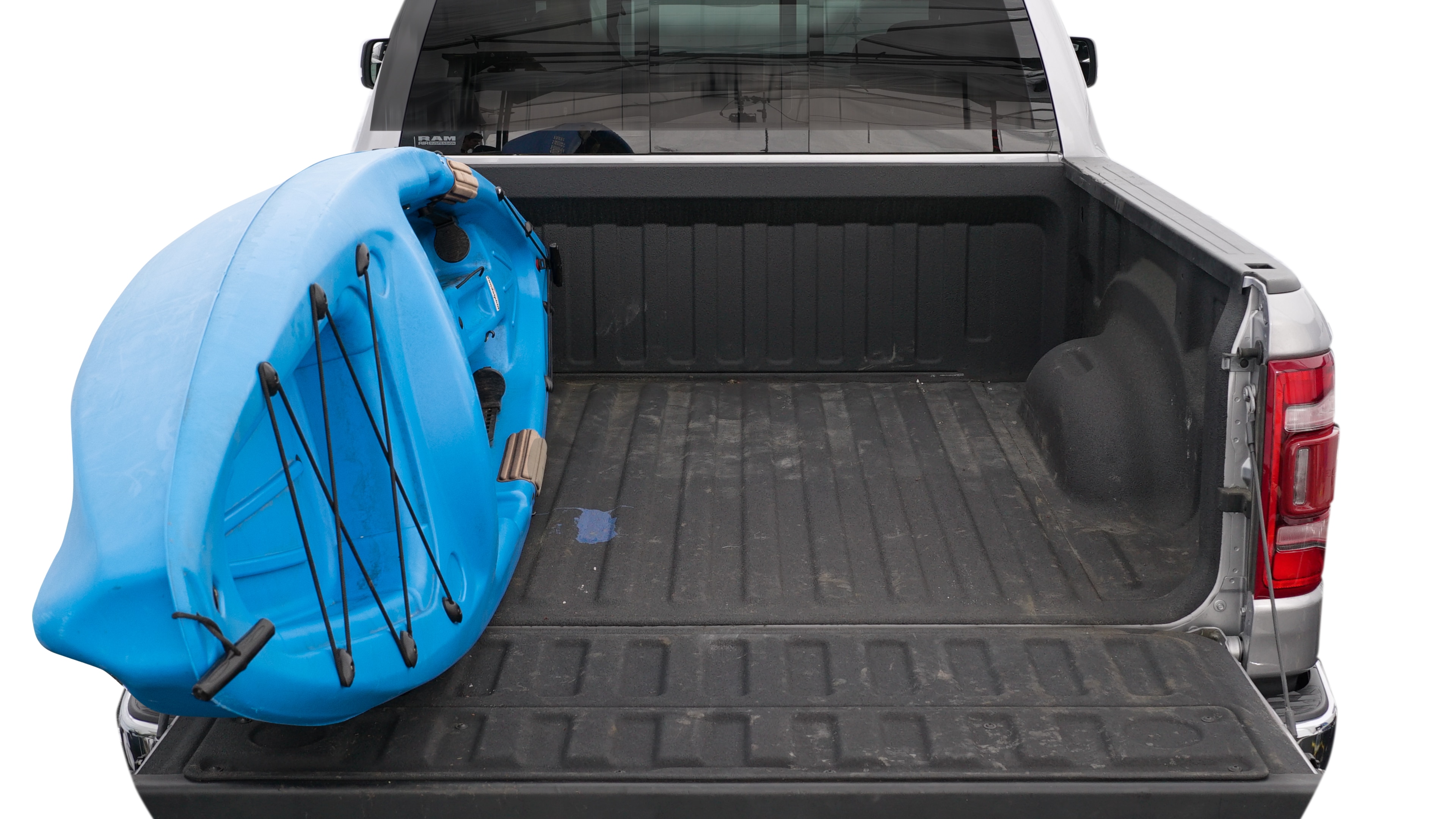 The trunk area is open giving a full view of the trunk area. A cooler, two camping chairs, a tailgate tent and a kayak are placed inside. 