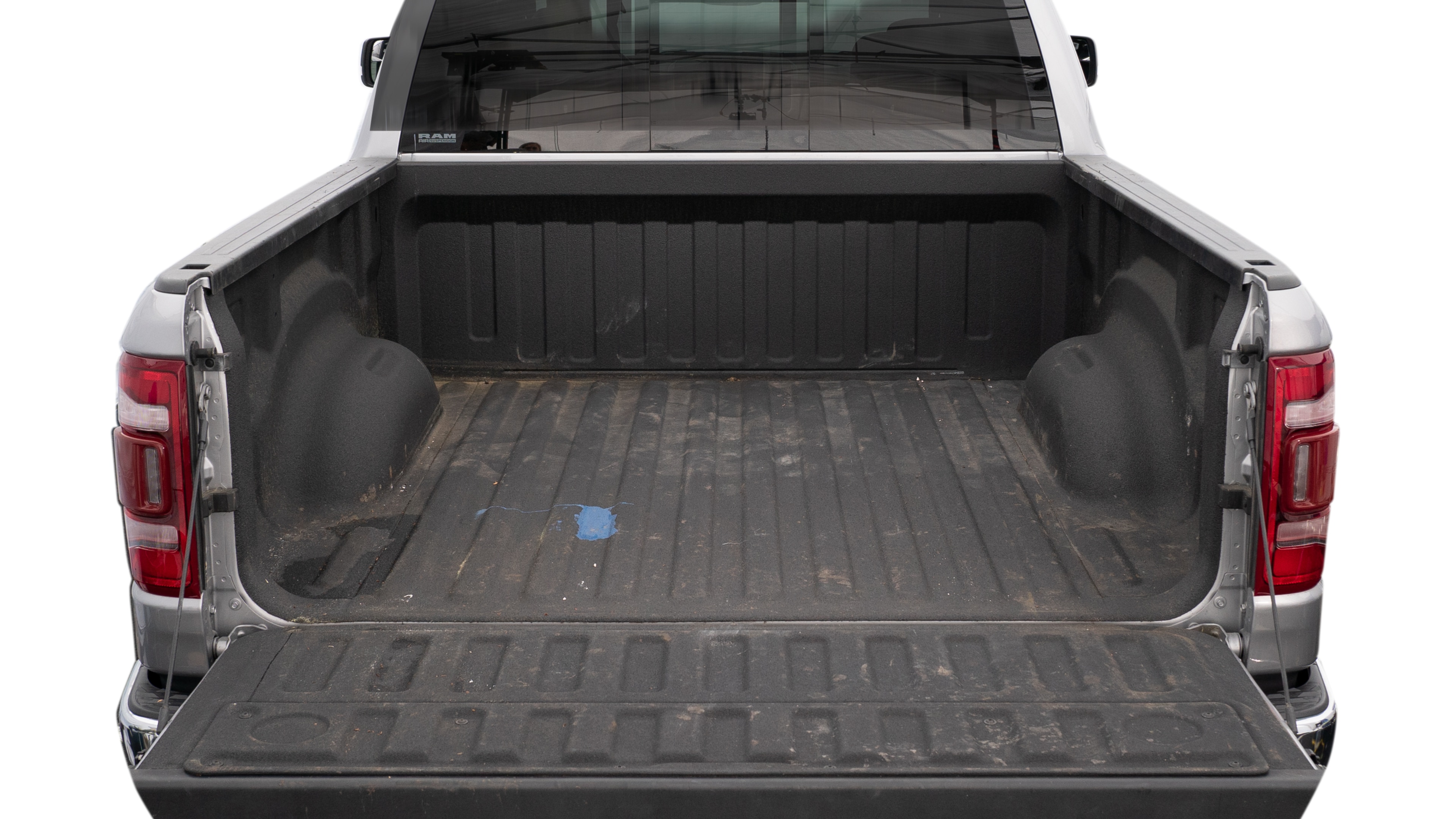 The trunk area is open giving a full view of the trunk area. A cooler, two camping chairs, a tailgate tent and a kayak are placed inside. 