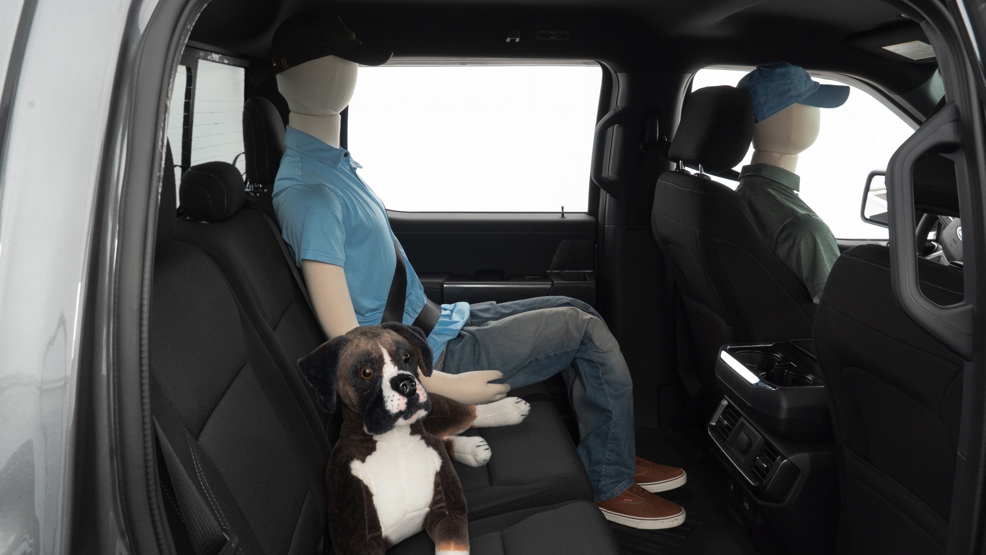 A series of second-row backseat photos is shown including one seating a baby seat and one seating a 6'1" mannequin.