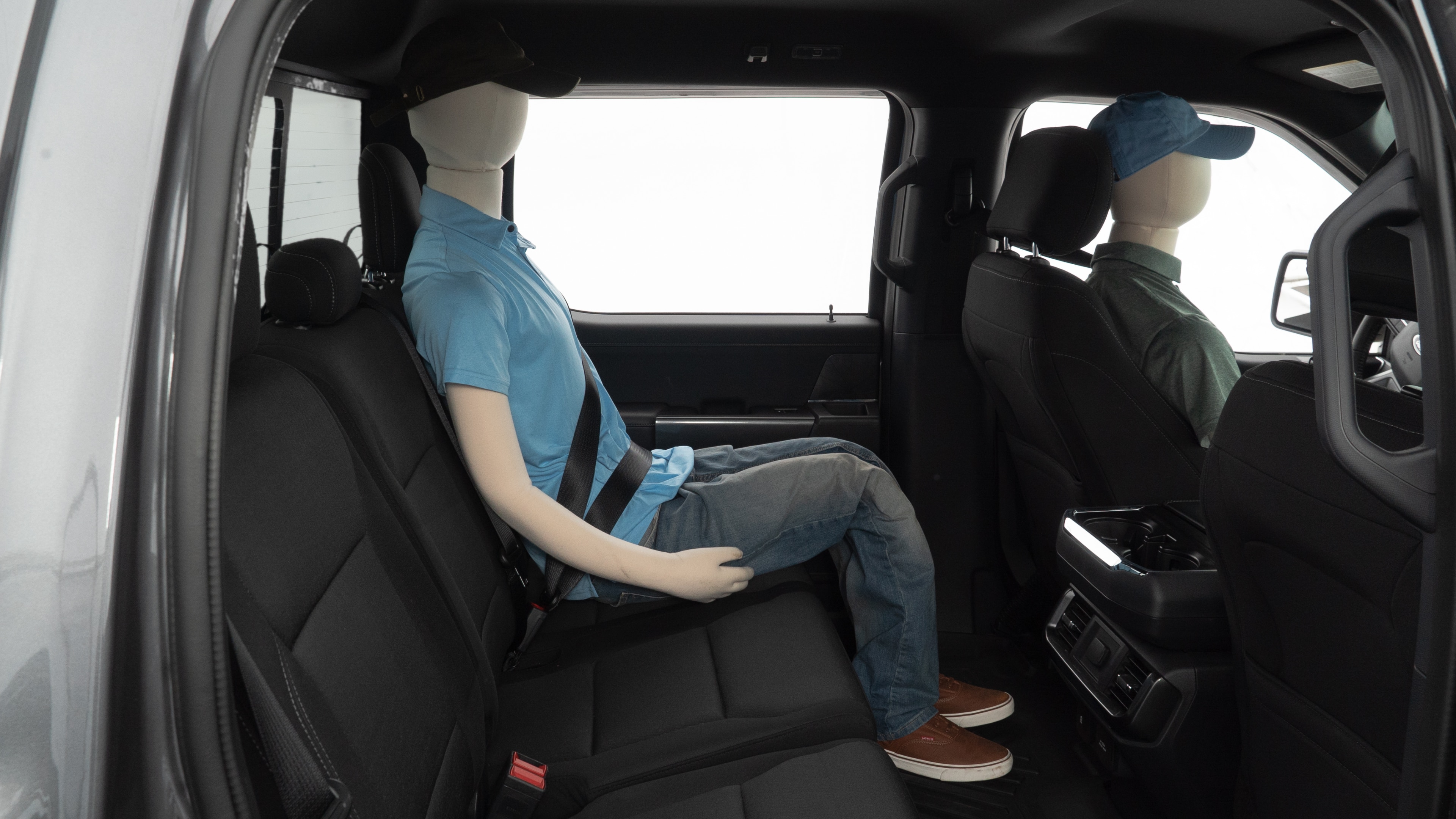 A series of second-row backseat photos is shown including one seating a baby seat and one seating a 6'1" mannequin.