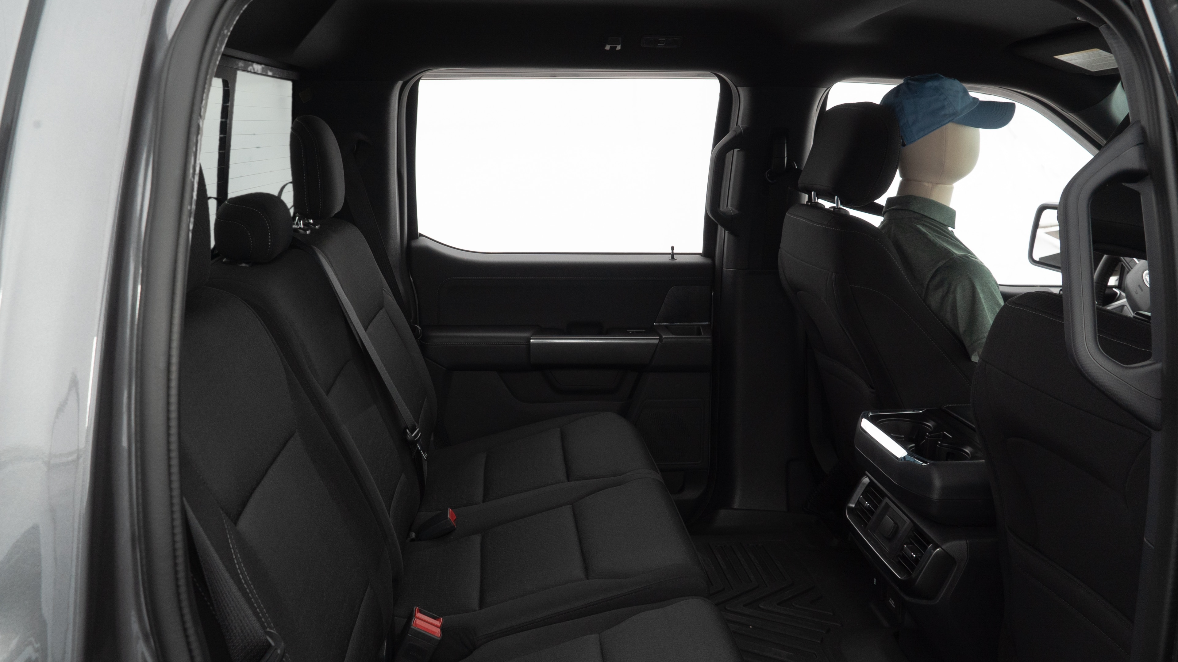 A series of second-row backseat photos is shown including one seating a baby seat and one seating a 6'1" mannequin.
