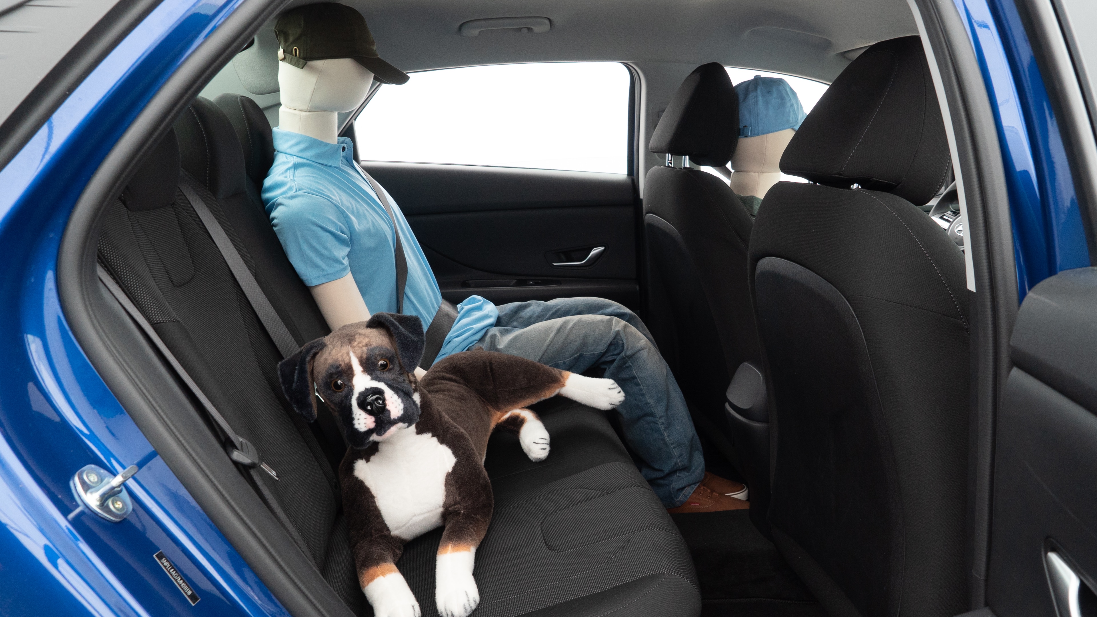 A series of second-row backseat photos is shown including one seating a baby seat and one seating a 6'1" mannequin.