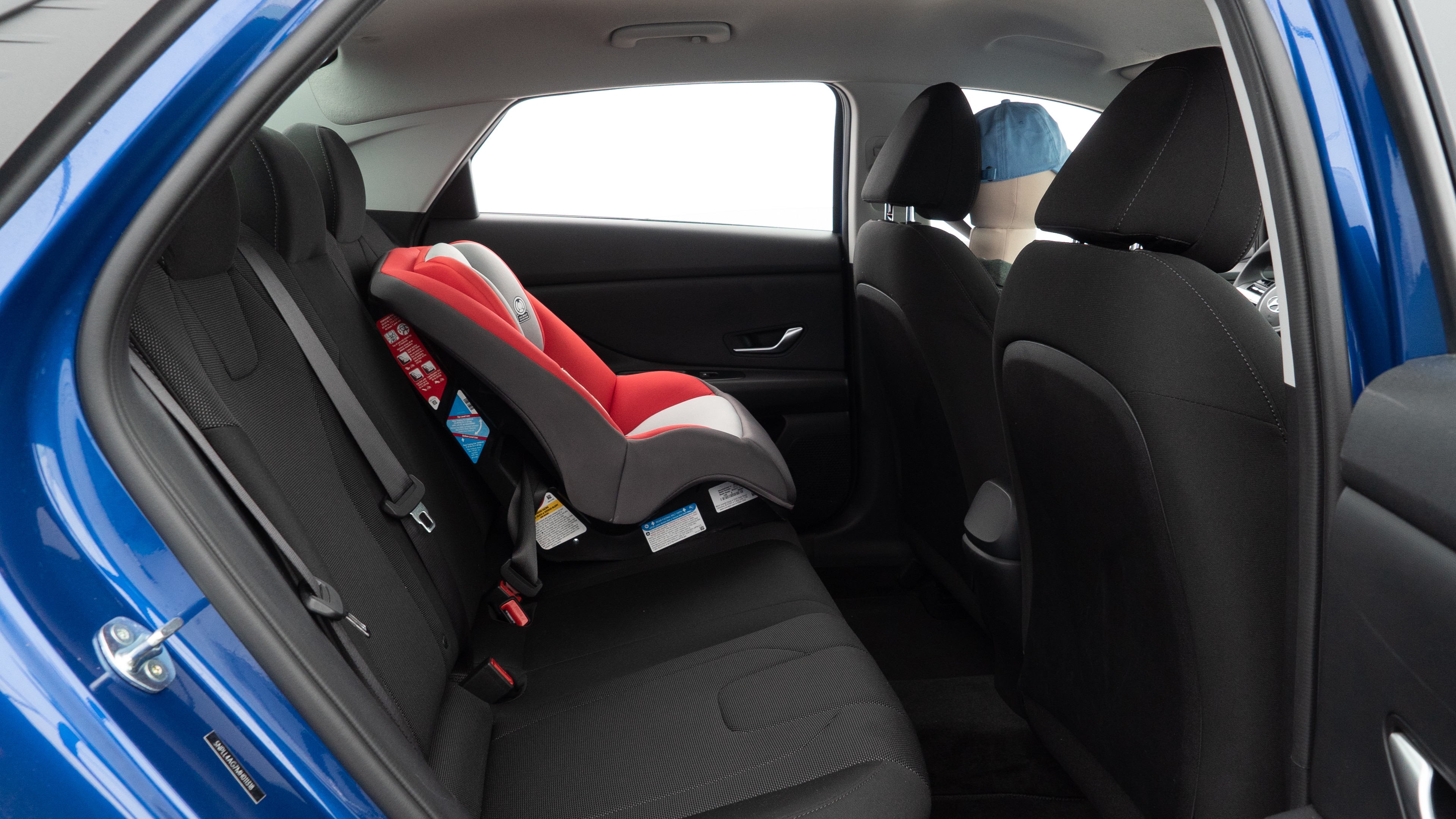 A series of second-row backseat photos is shown including one seating a baby seat and one seating a 6'1" mannequin.
