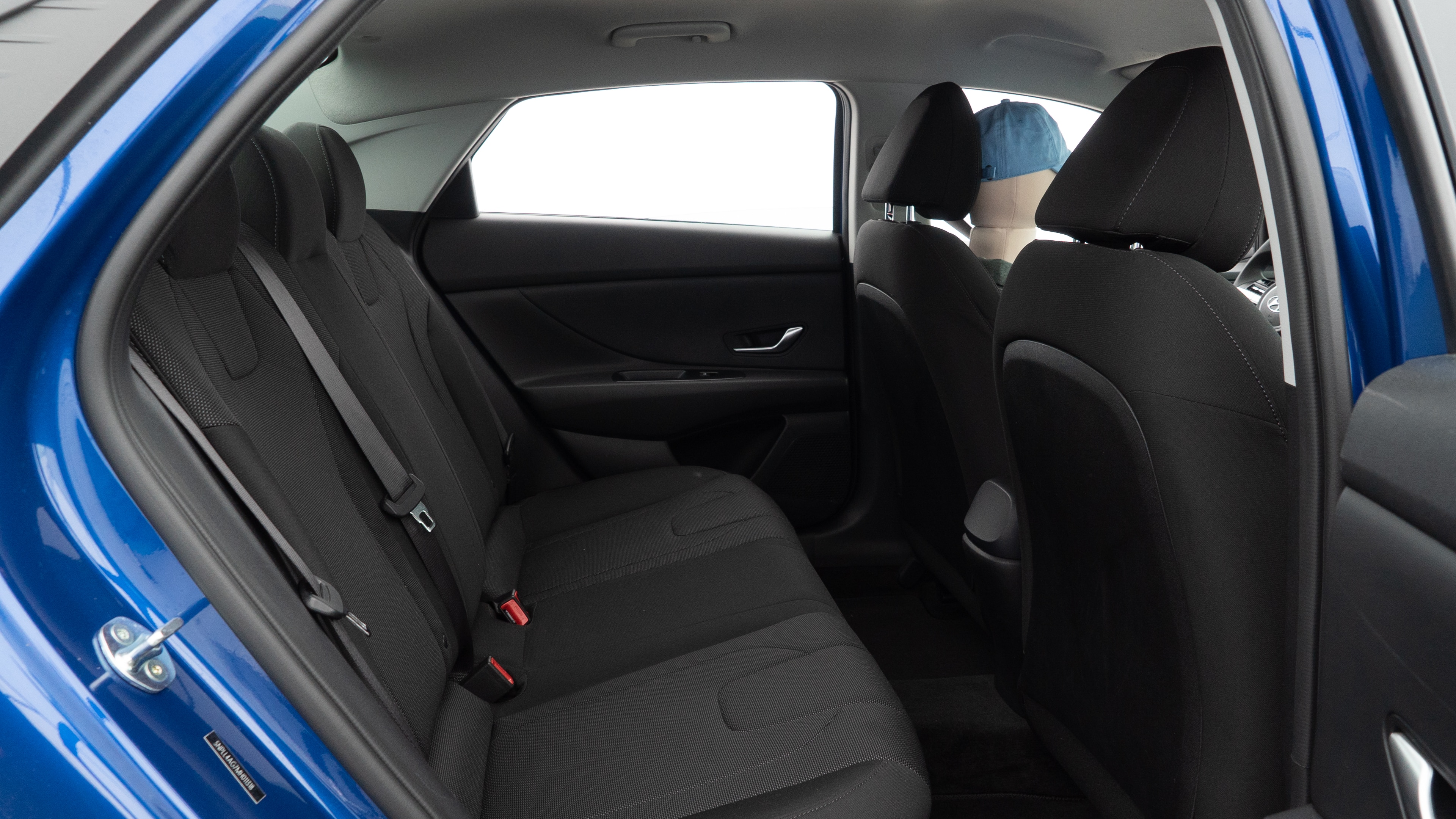 A series of second-row backseat photos is shown including one seating a baby seat and one seating a 6'1" mannequin.
