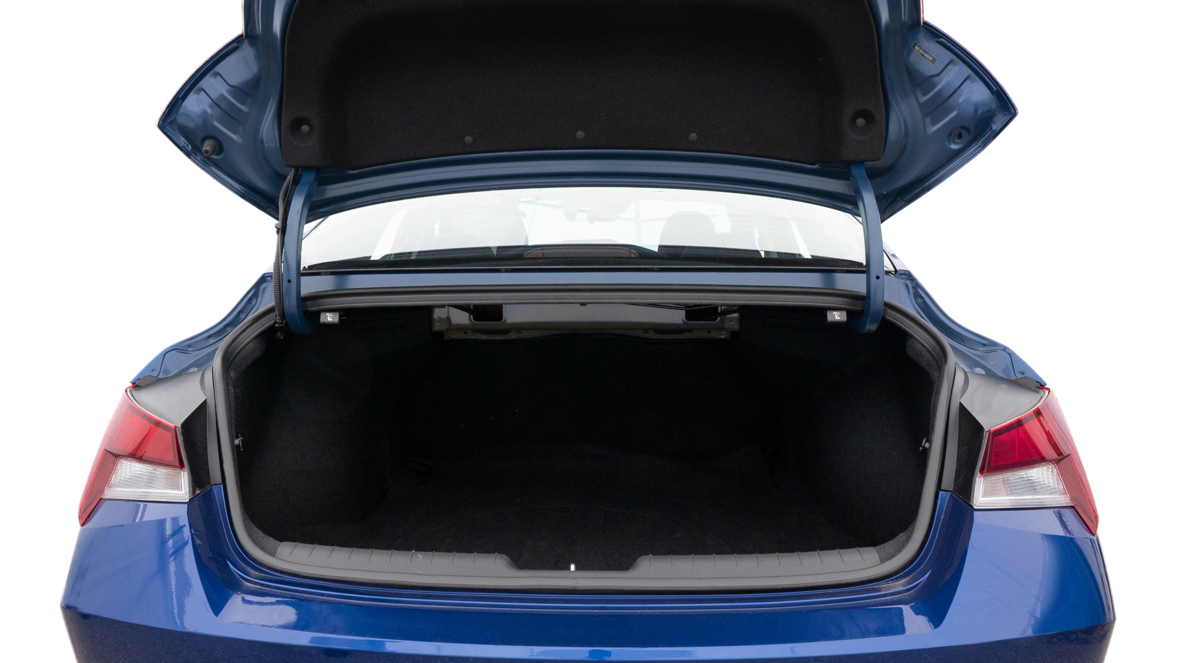 The trunk lid is open showing full view of the trunk. A baby stroller, three grocery carriers, two camping chairs in the carrying bag, and a set of golf clubs are placed inside.