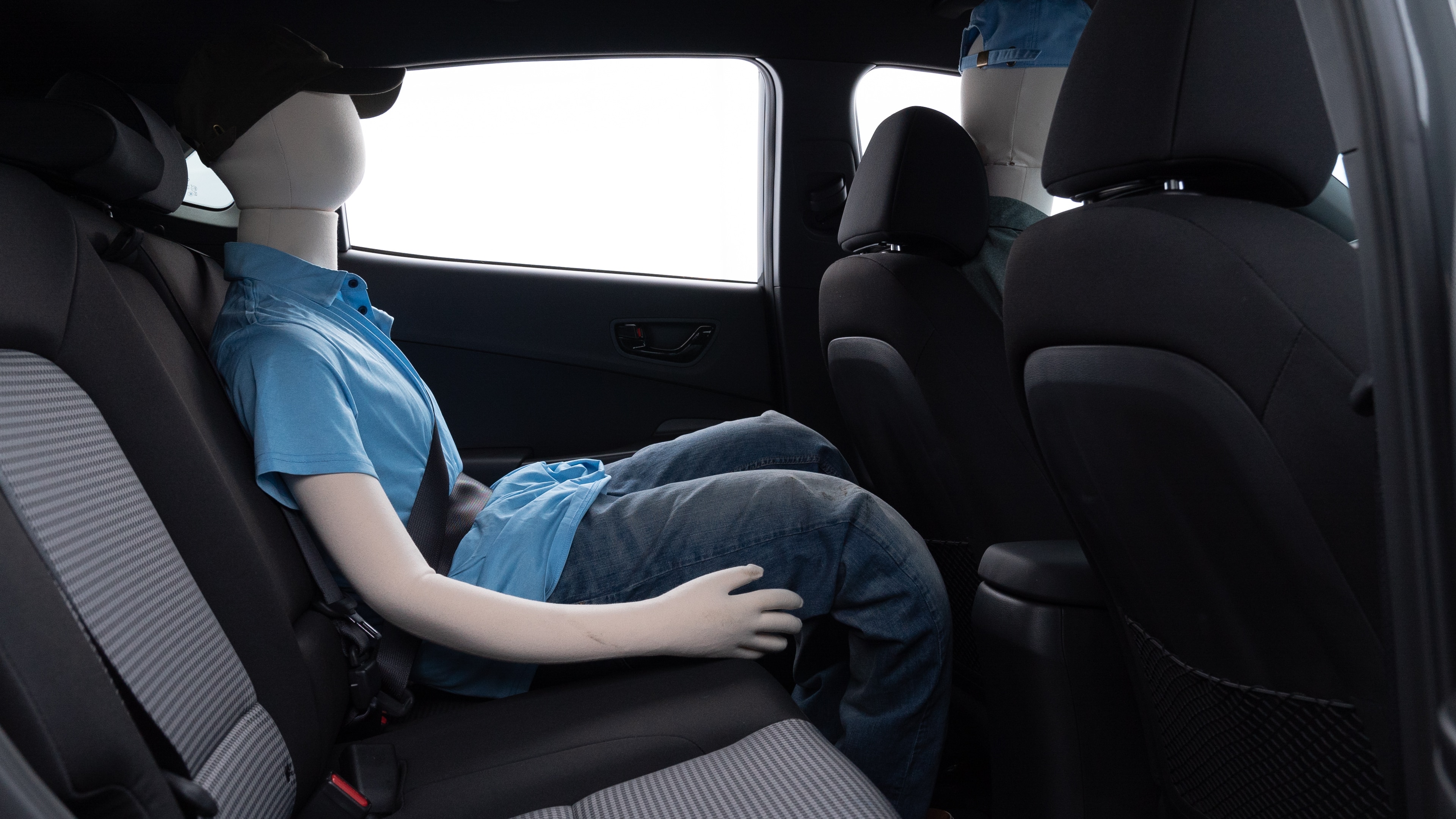 A series of second-row backseat photos is shown including one seating a baby seat and one seating a 6'1" mannequin.