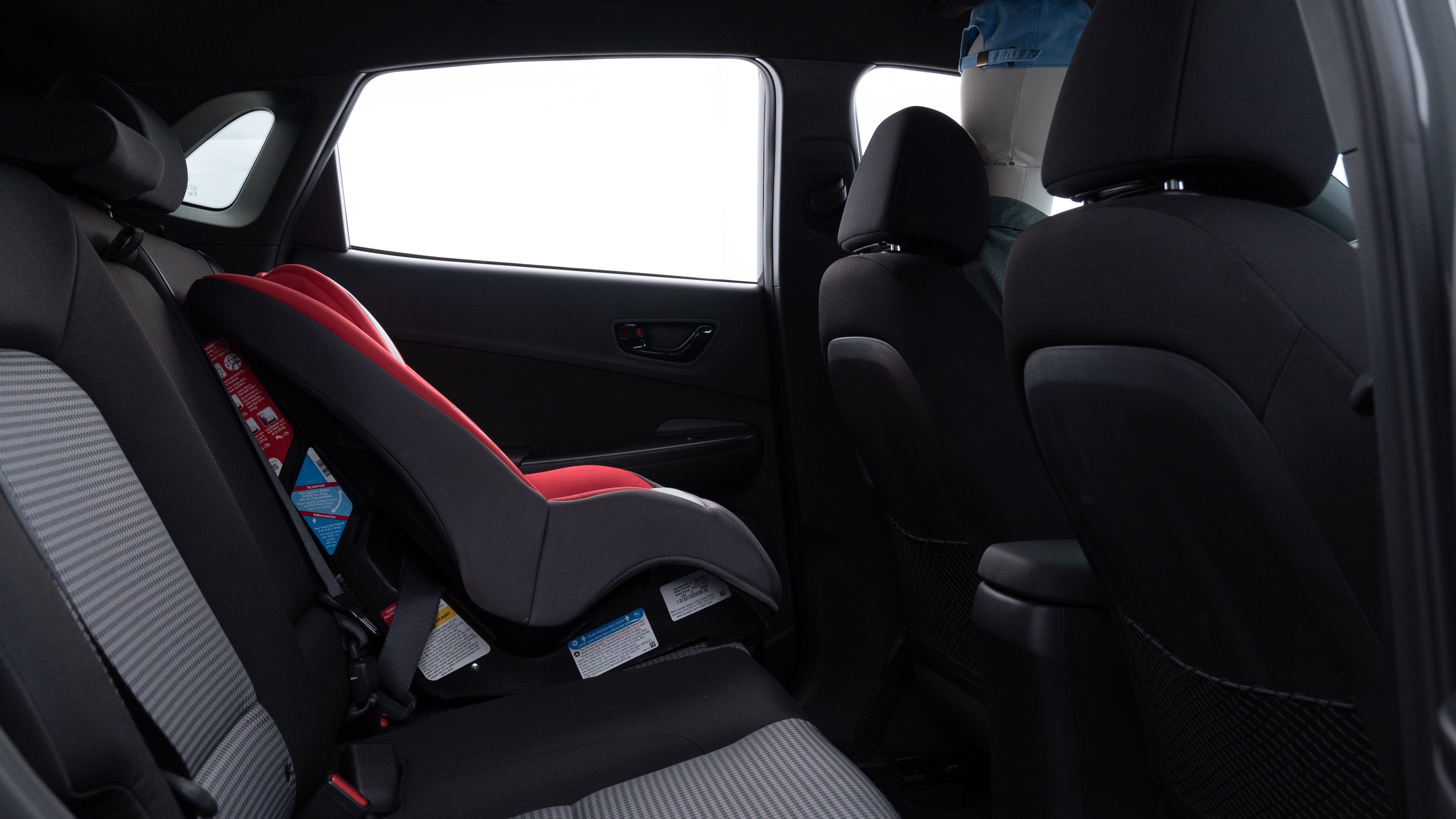 A series of second-row backseat photos is shown including one seating a baby seat and one seating a 6'1" mannequin.