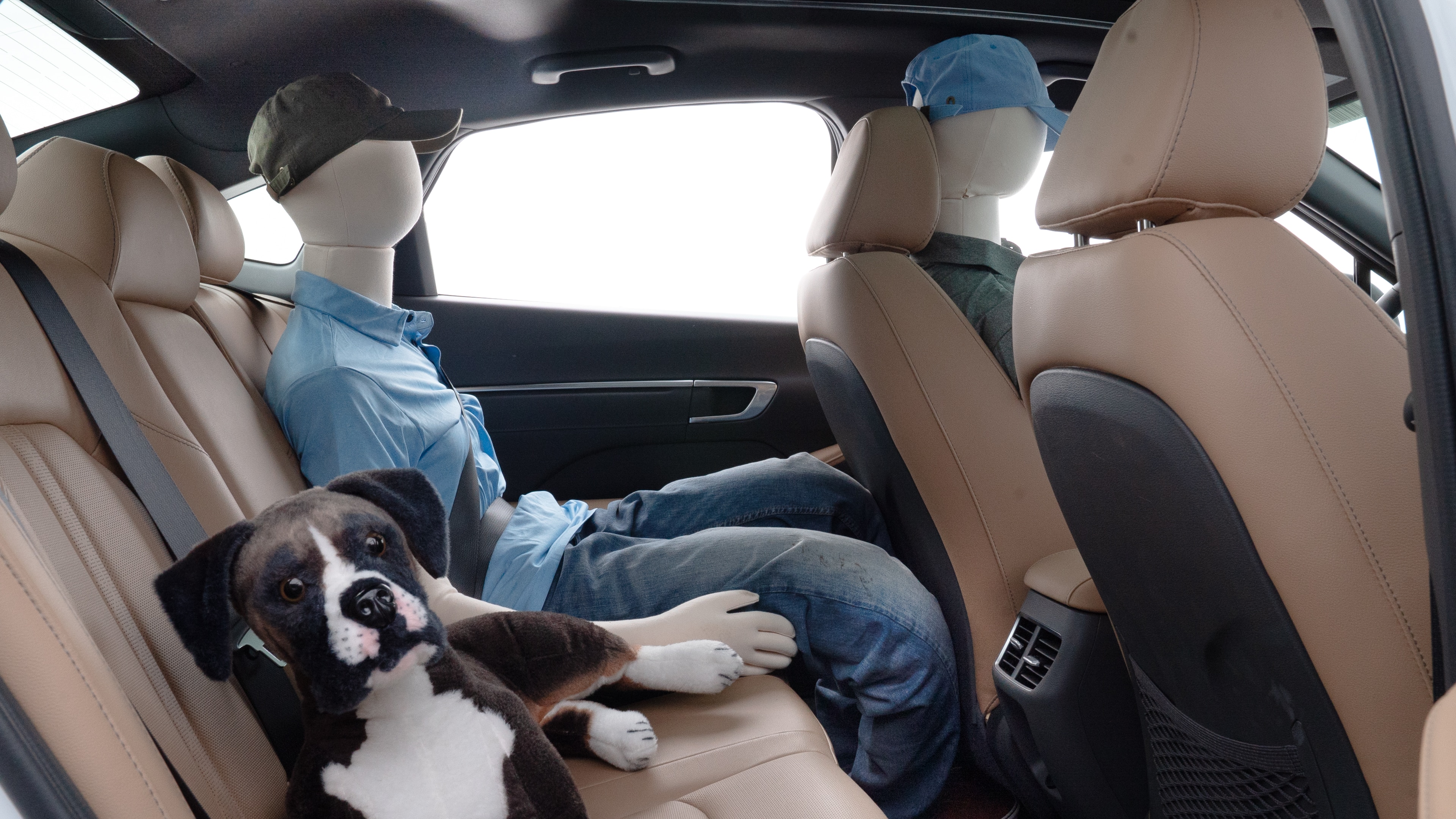 A series of second-row backseat photos is shown including one seating a baby seat and one seating a 6'1" mannequin.