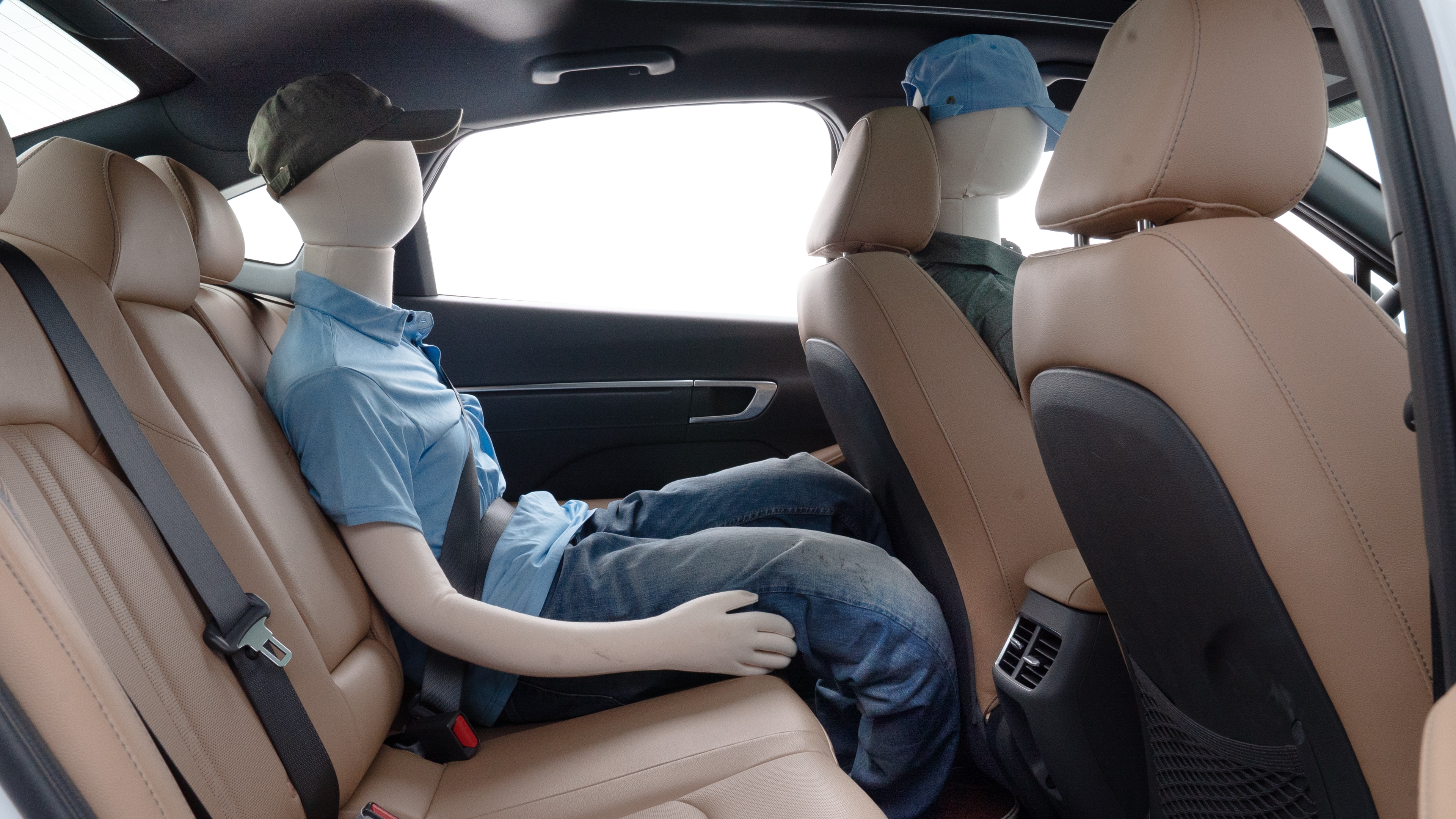 A series of second-row backseat photos is shown including one seating a baby seat and one seating a 6'1" mannequin.