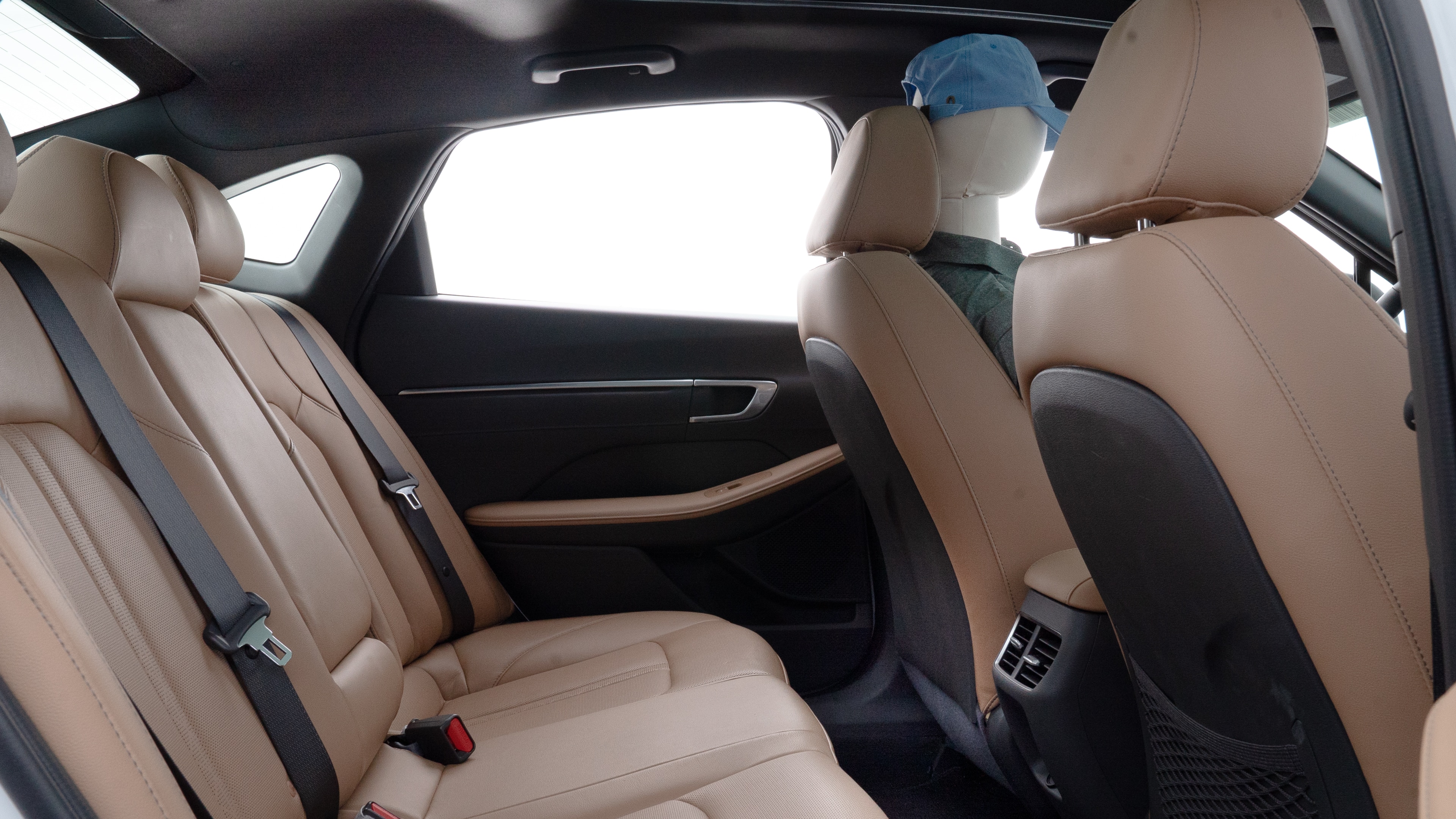 A series of second-row backseat photos is shown including one seating a baby seat and one seating a 6'1" mannequin.
