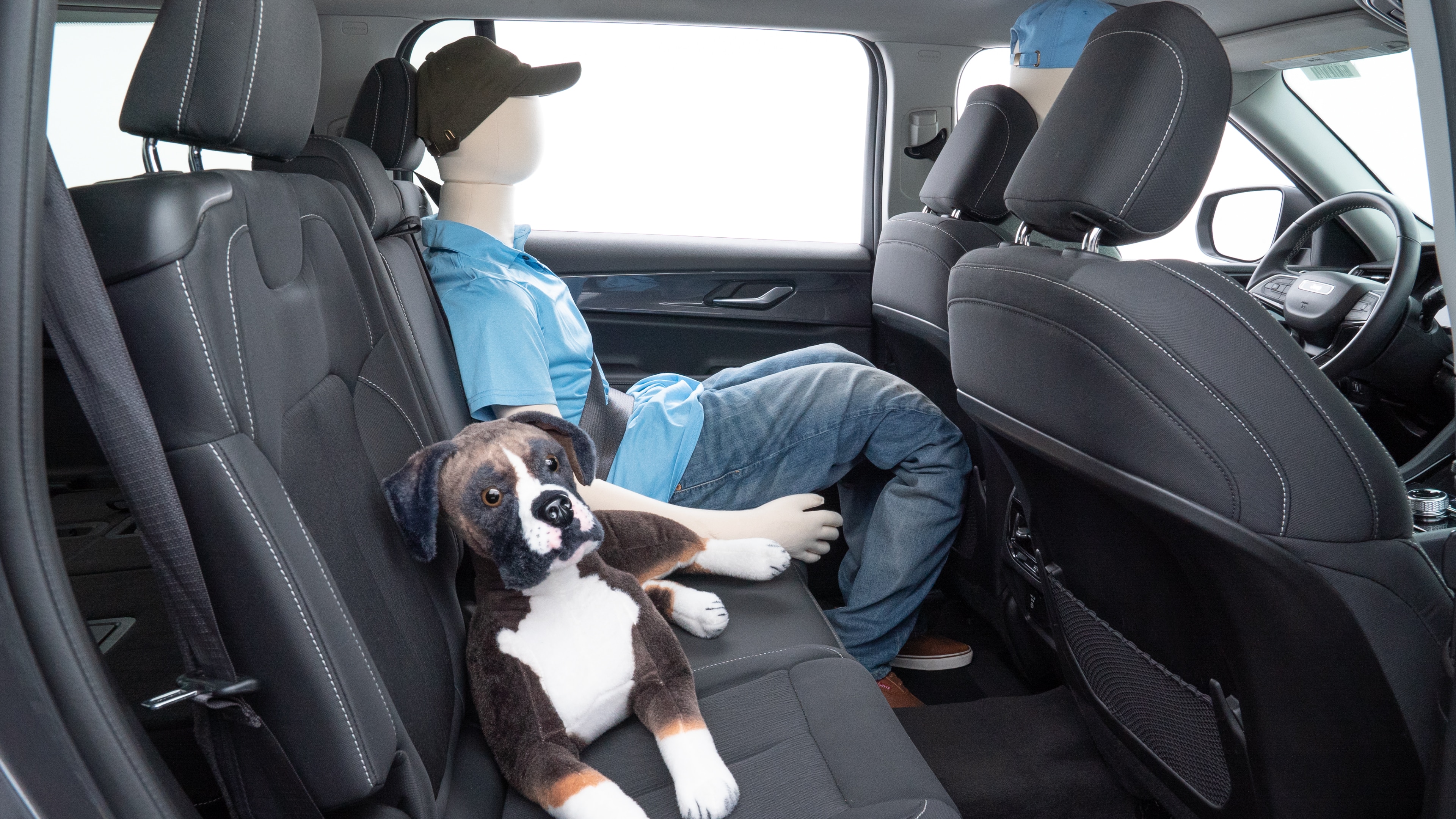A series of second-row backseat photos is shown including one seating a baby seat and one seating a 6'1" mannequin.