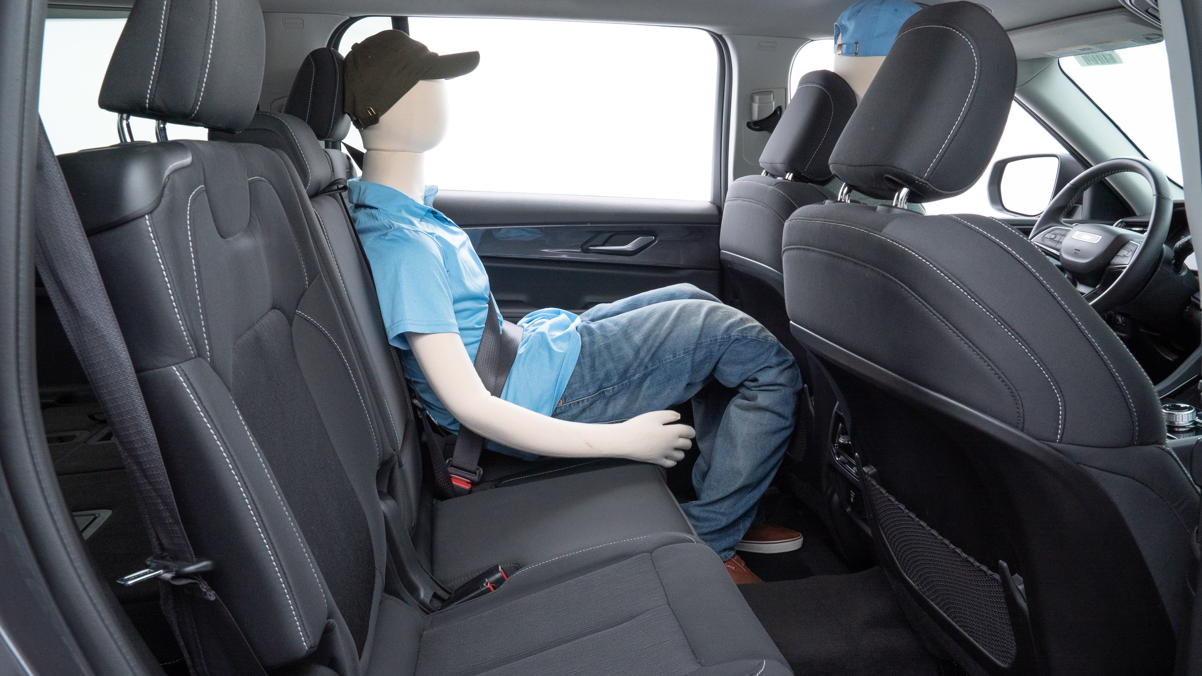 A series of second-row backseat photos is shown including one seating a baby seat and one seating a 6'1" mannequin.