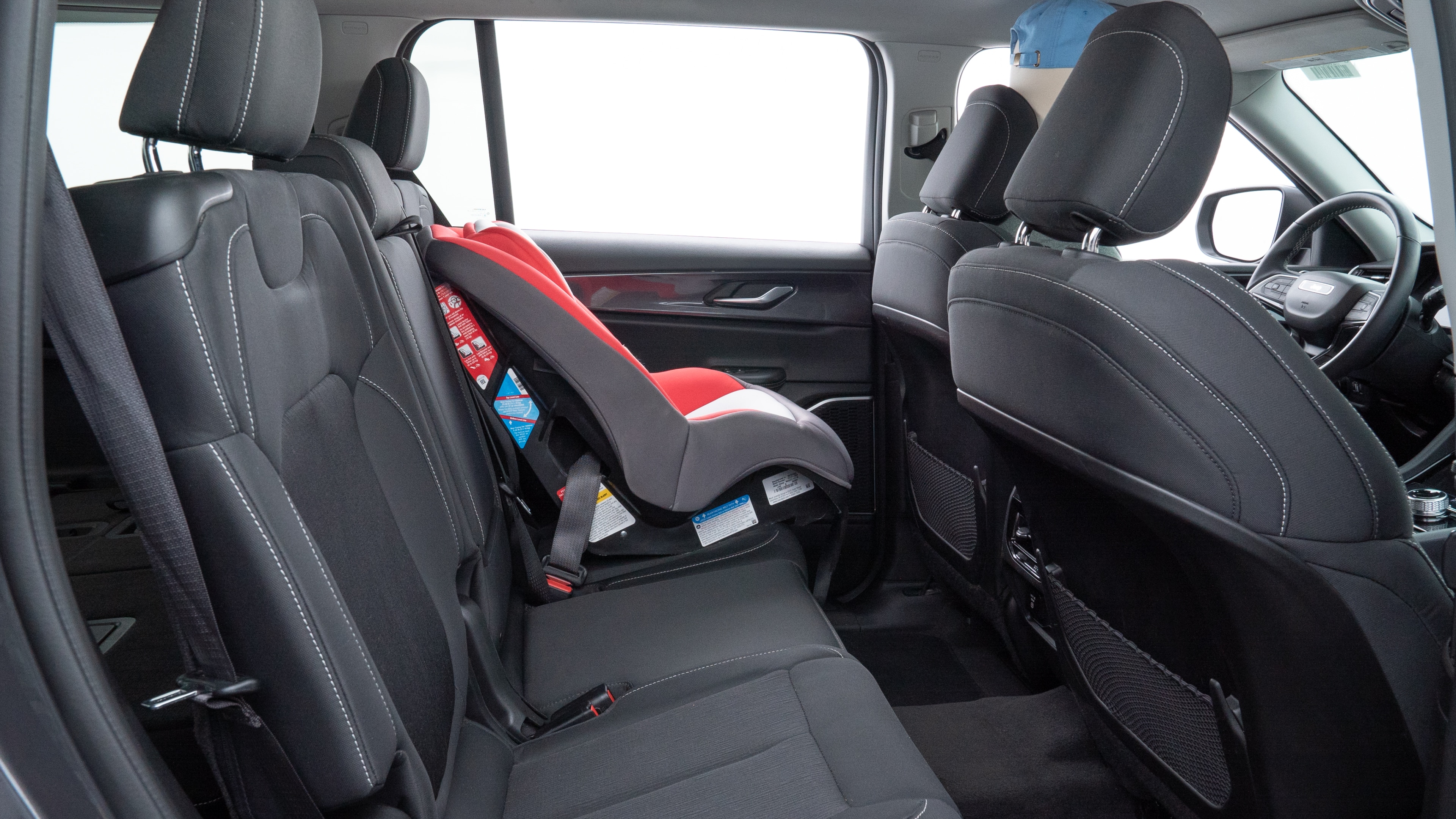 A series of second-row backseat photos is shown including one seating a baby seat and one seating a 6'1" mannequin.