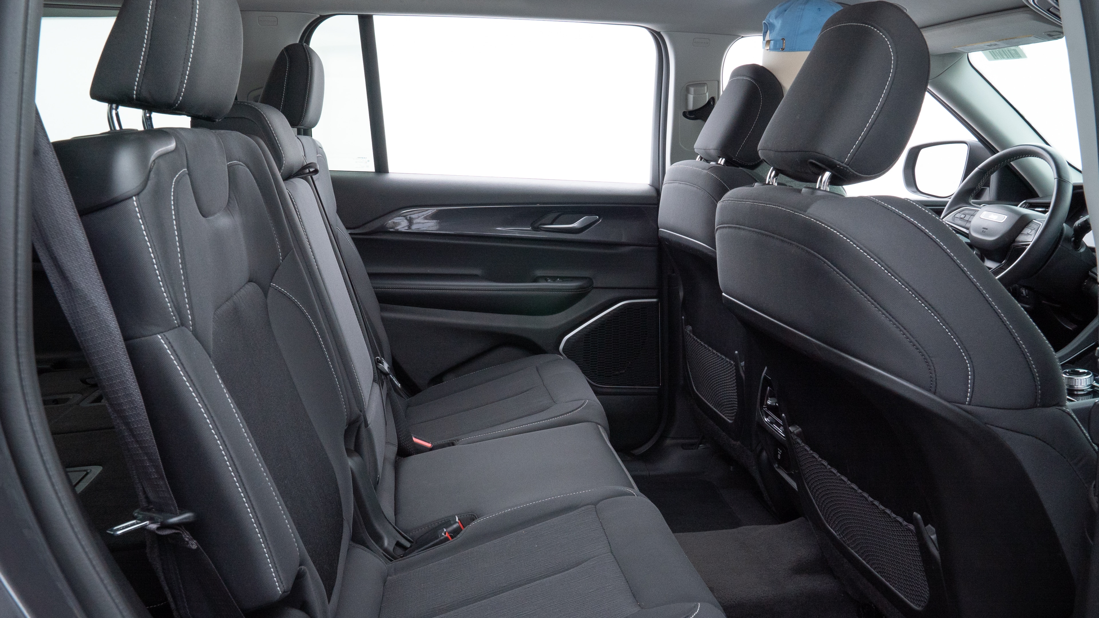 A series of second-row backseat photos is shown including one seating a baby seat and one seating a 6'1" mannequin.