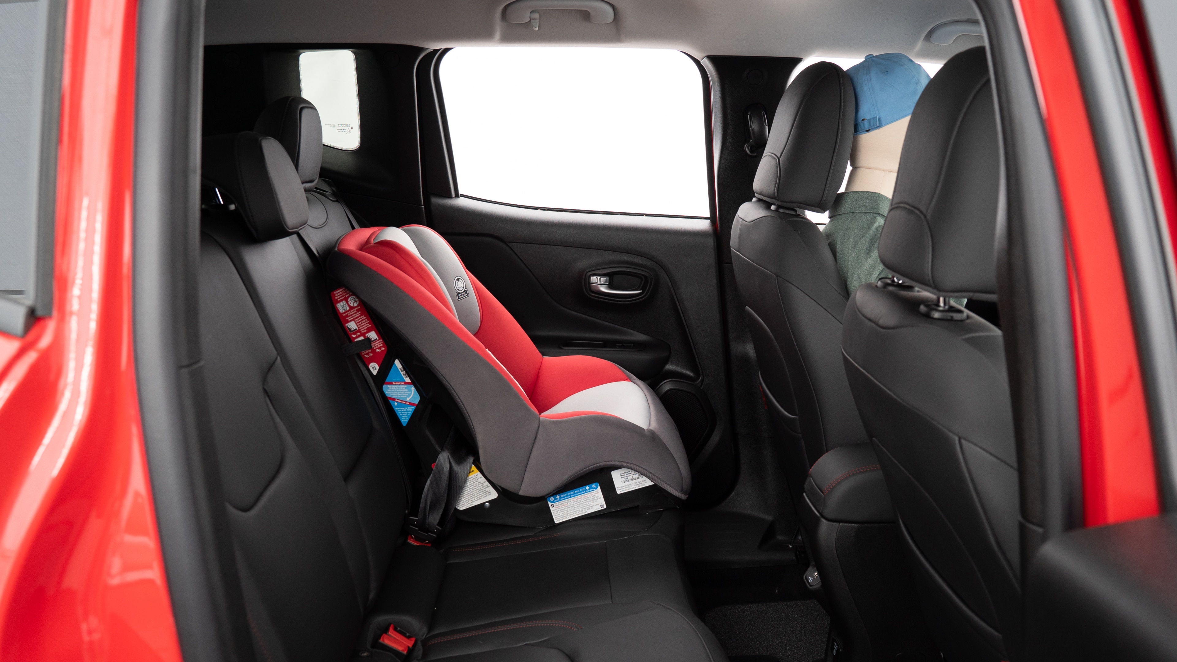 A series of second-row backseat photos is shown including one seating a baby seat, a dog and one seating a 6'1" mannequin.