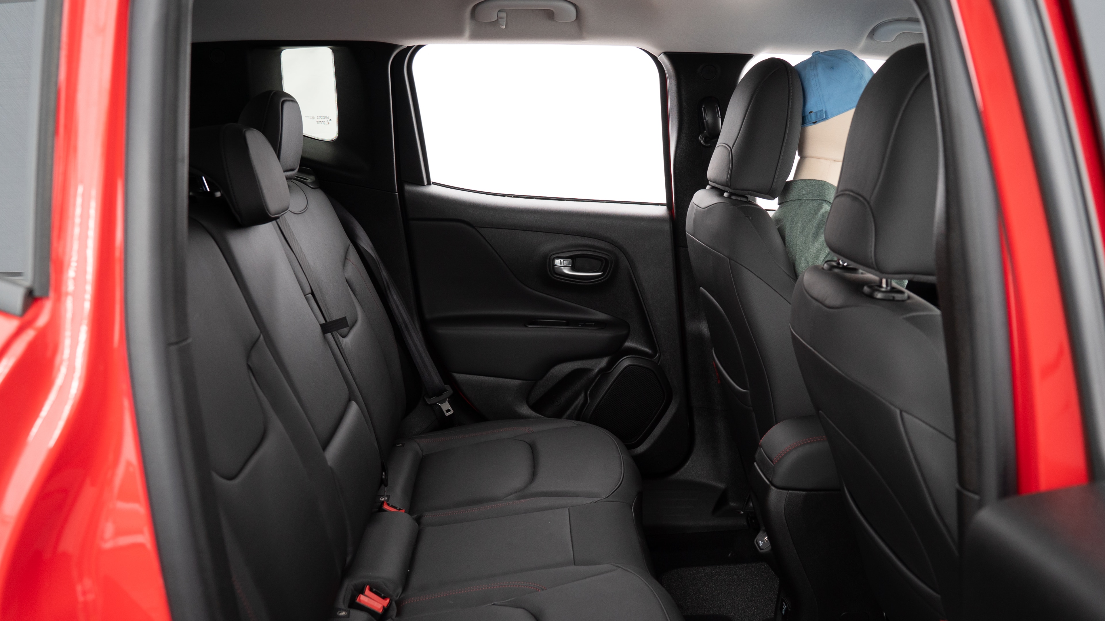 A series of second-row backseat photos is shown including one seating a baby seat, a dog and one seating a 6'1" mannequin.