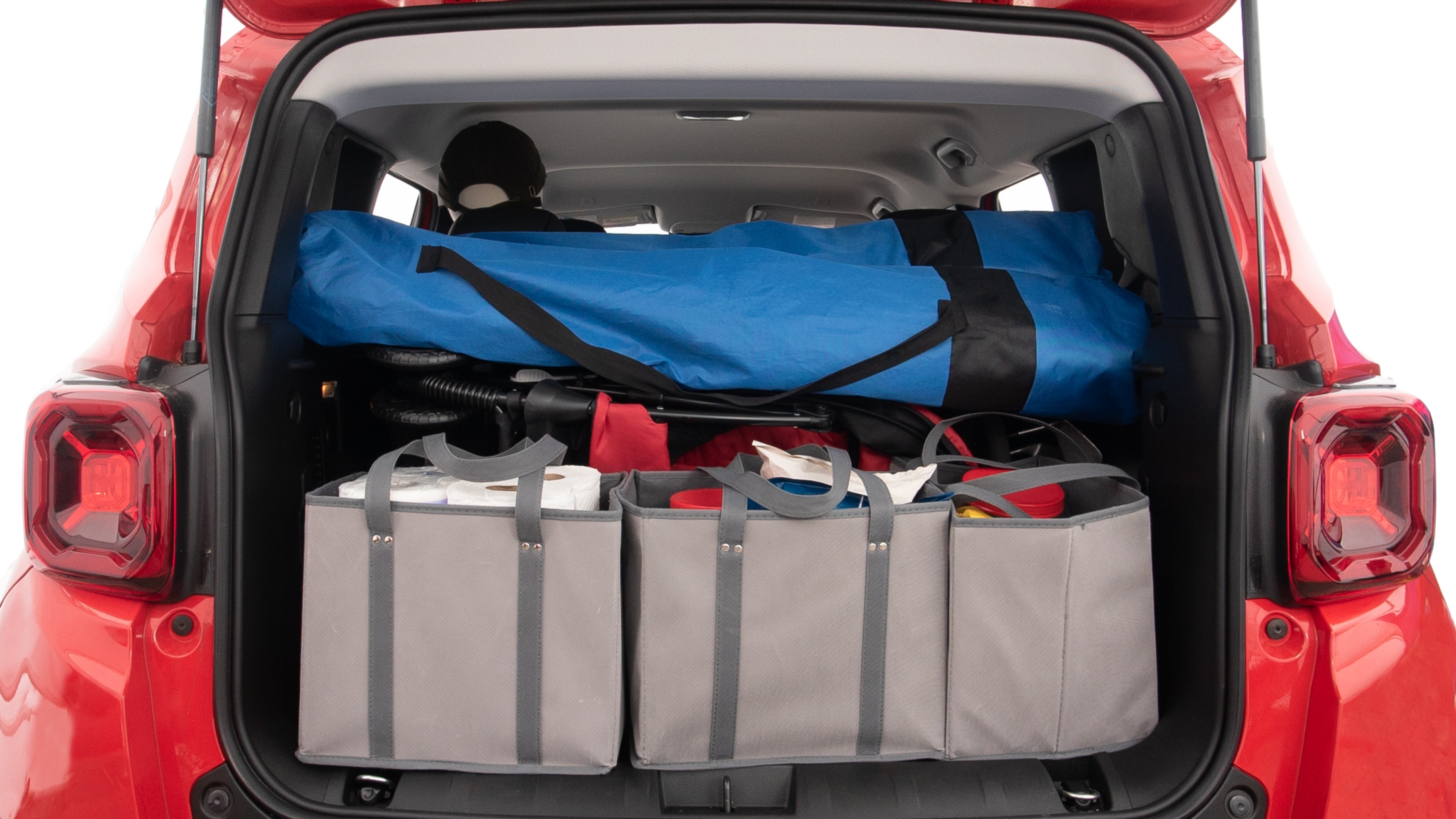 The trunk lid is open showing full view of the trunk. A baby stroller, three grocery carriers, two camping chairs in the carrying bag, and a set of golf clubs are placed inside.