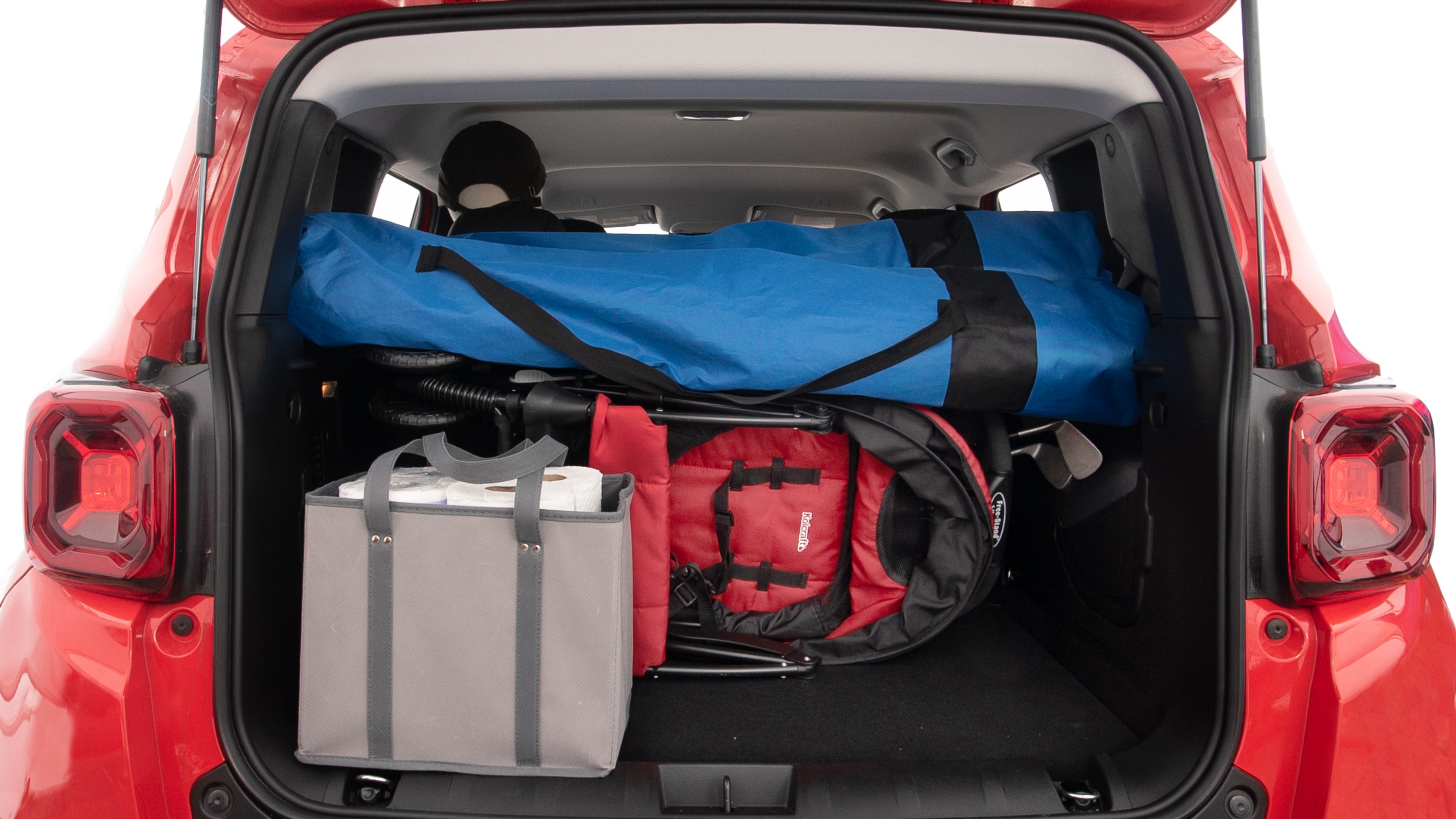 The trunk lid is open showing full view of the trunk. A baby stroller, three grocery carriers, two camping chairs in the carrying bag, and a set of golf clubs are placed inside.