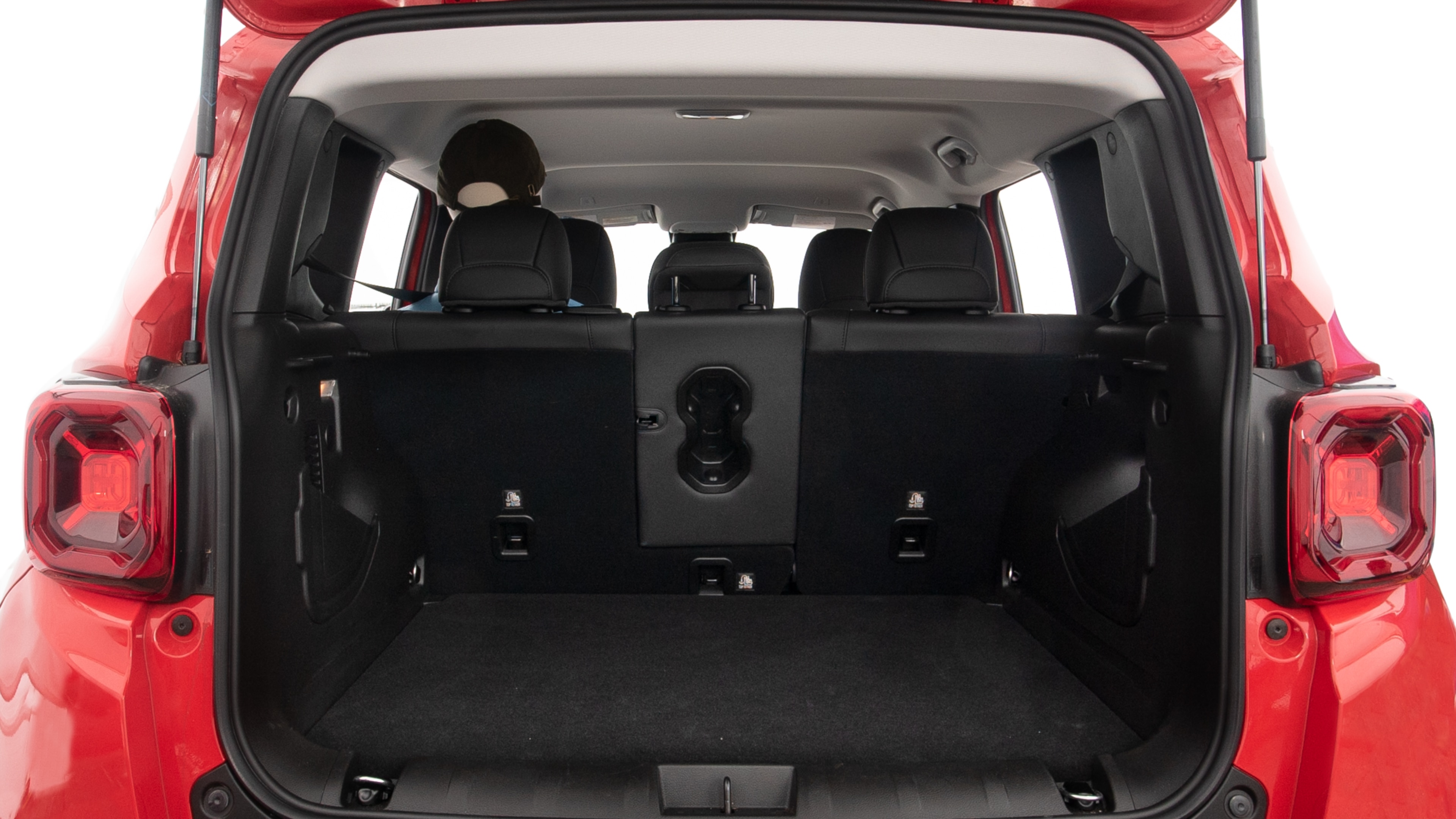 The trunk lid is open, showing full view of the trunk space. One extra large and two large suitcases are placed inside.