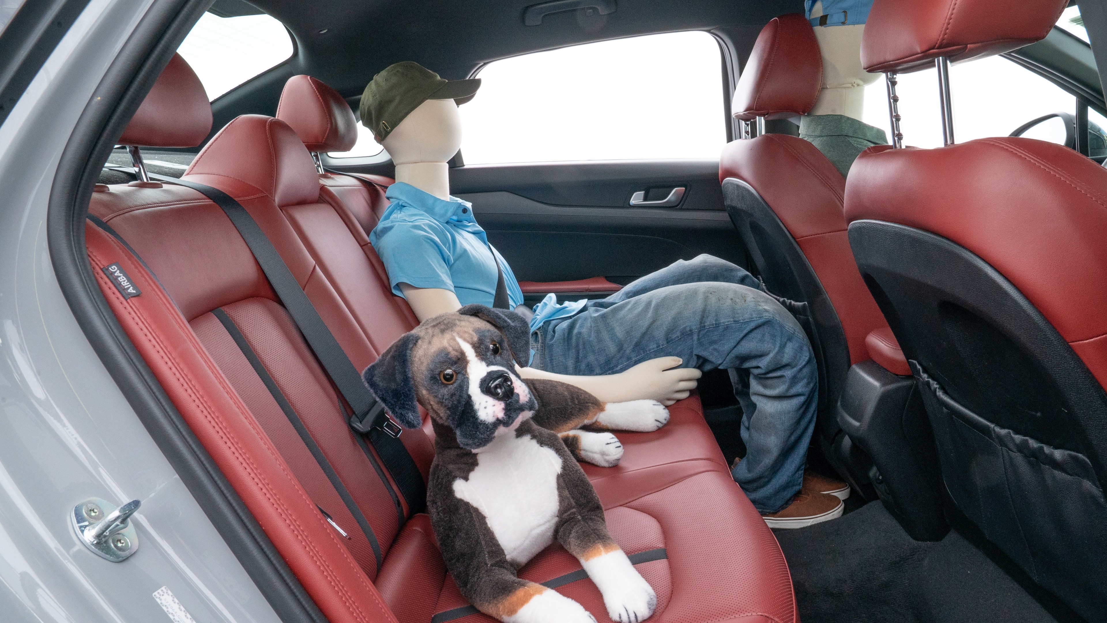 A series of second-row backseat photos is shown including one seating a baby seat and one seating a 6'1" mannequin.