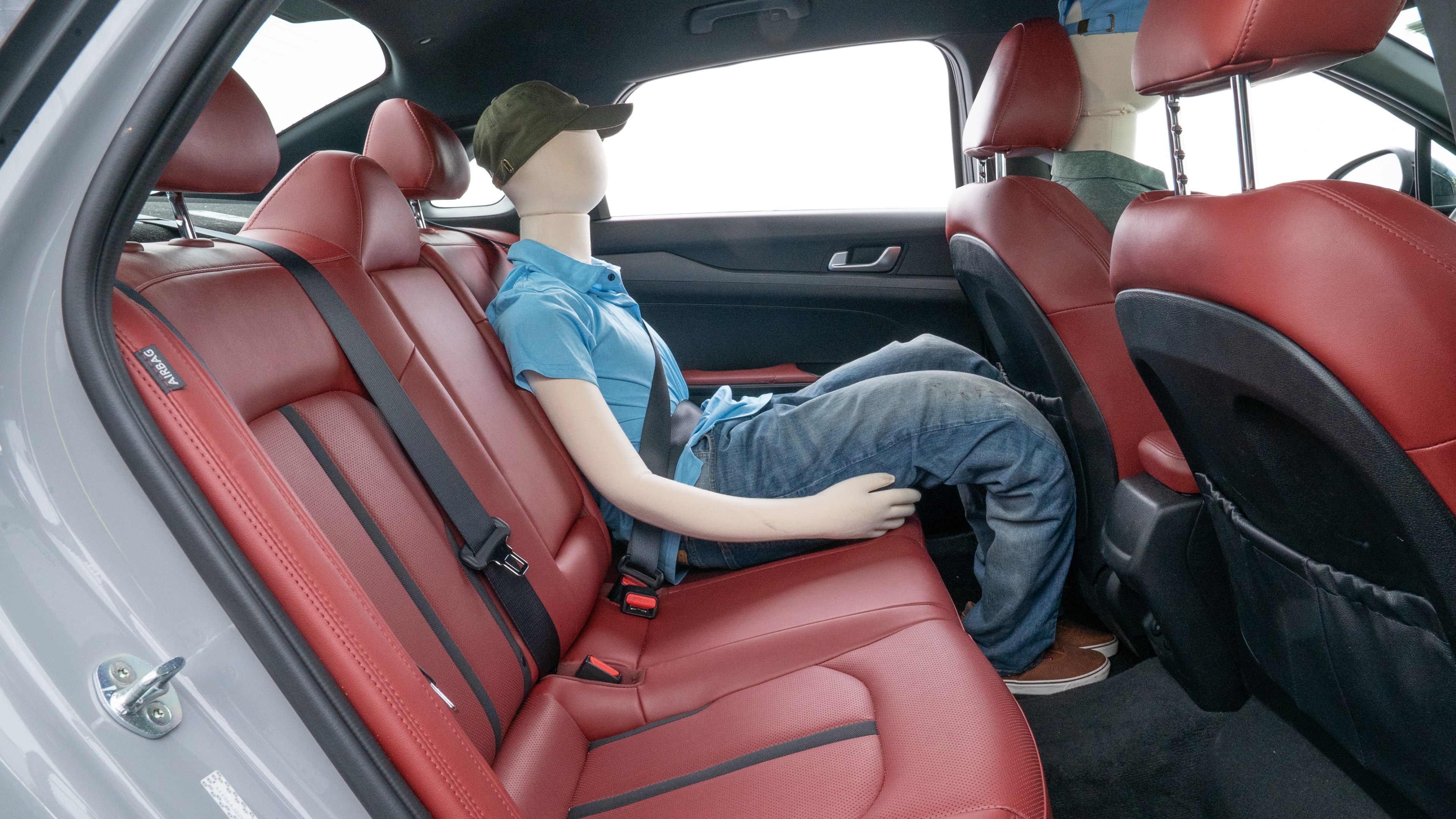 A series of second-row backseat photos is shown including one seating a baby seat and one seating a 6'1" mannequin.