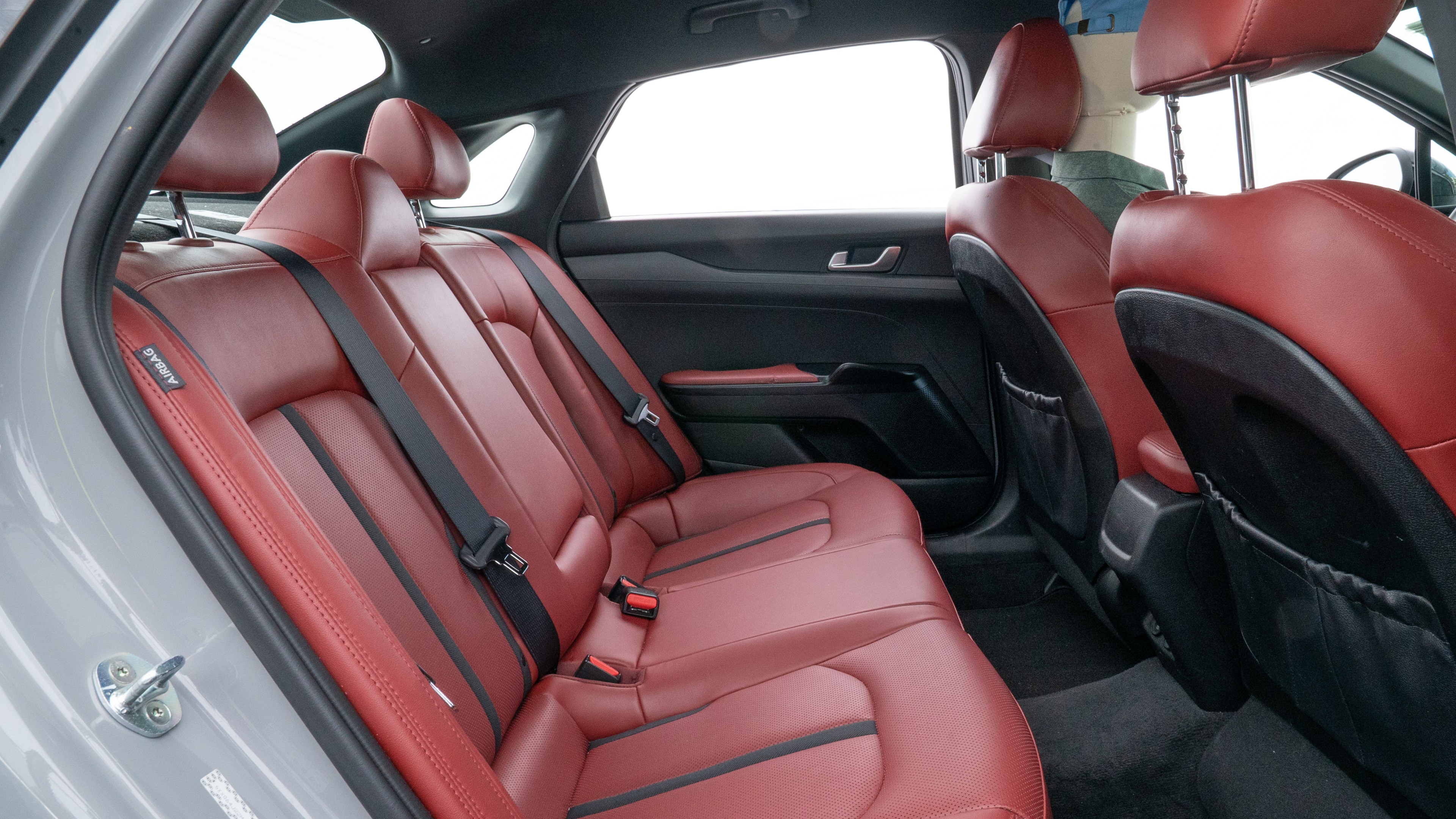 A series of second-row backseat photos is shown including one seating a baby seat and one seating a 6'1" mannequin.