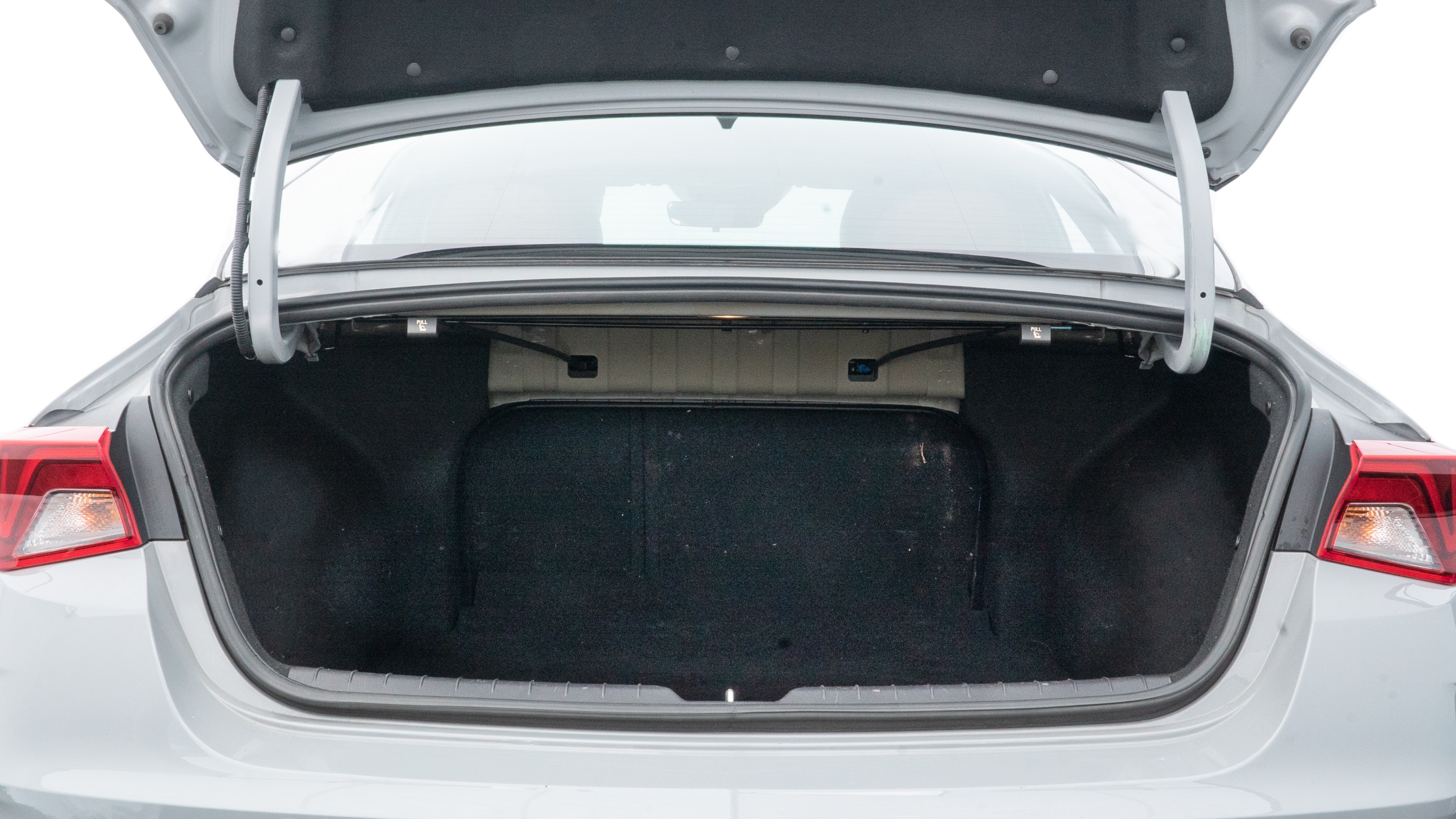The trunk lid is open showing full view of the trunk. A baby stroller, three grocery carriers, two camping chairs in the carrying bag, and a set of golf clubs are placed inside.