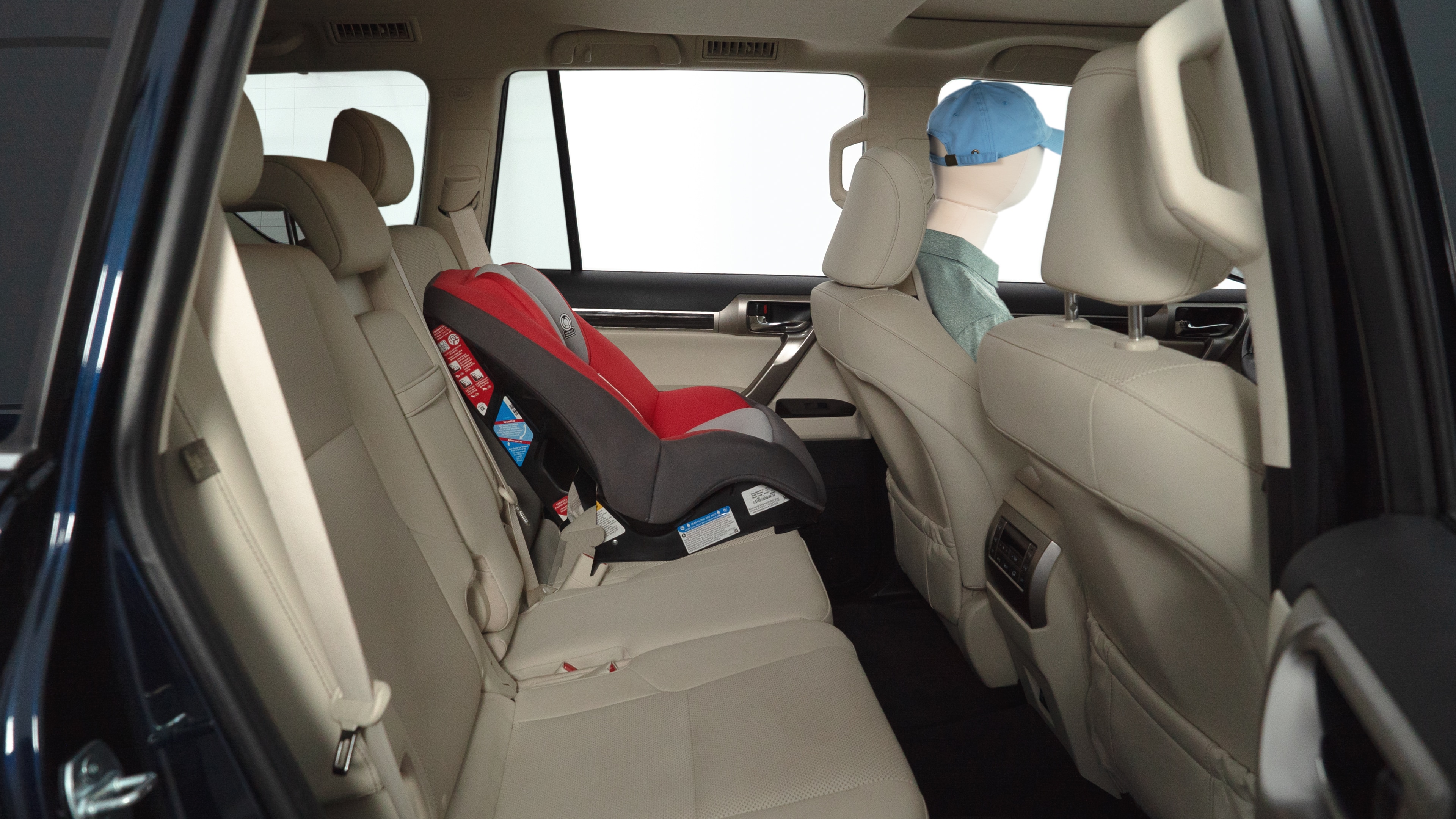 A series of second-row backseat photos is shown including one seating a baby seat and one seating a 6'1" mannequin.