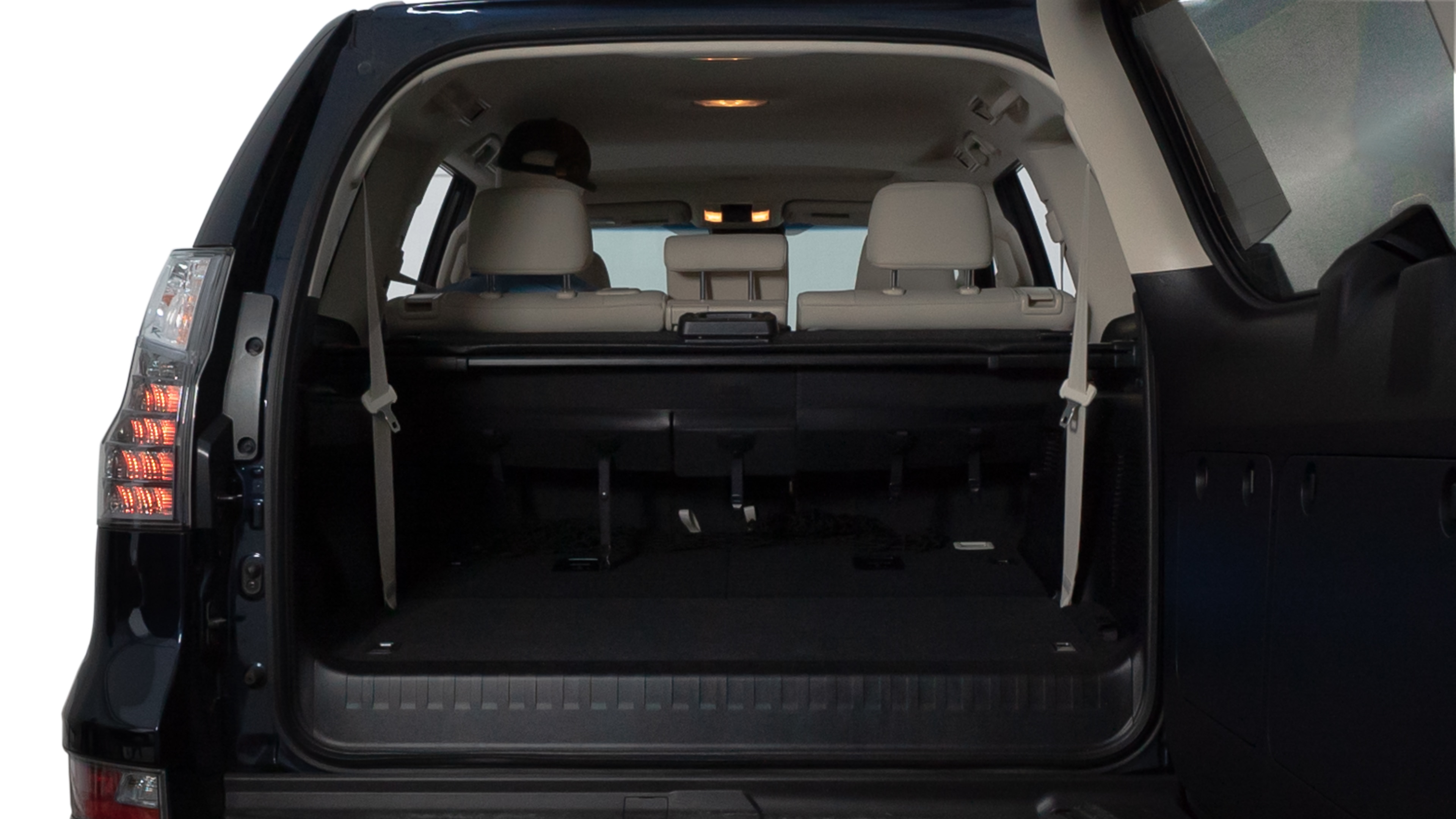 The trunk lid is open showing full view of the trunk. A baby stroller, three grocery carriers, two camping chairs in the carrying bag, and a set of golf clubs are placed inside.