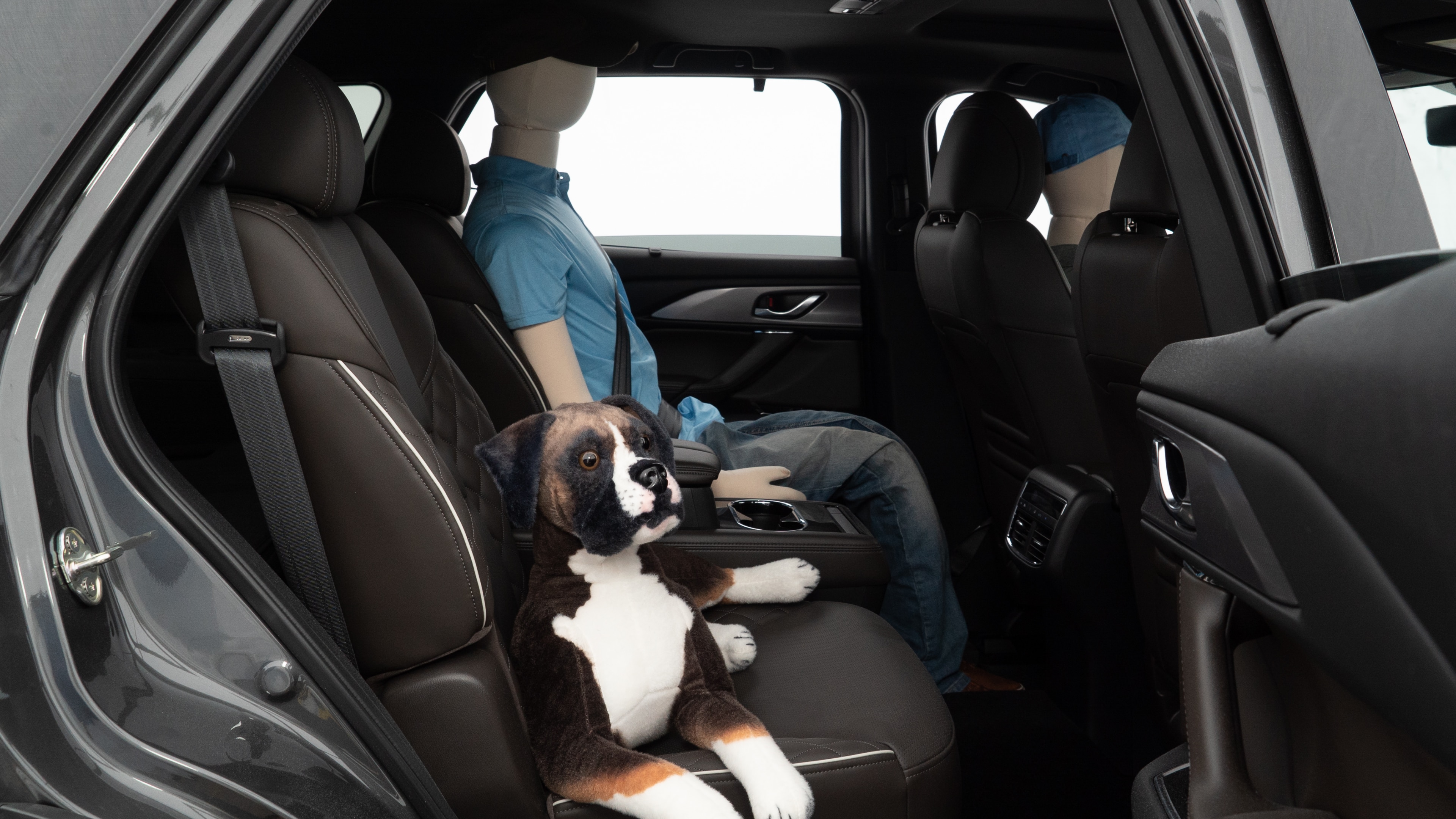 A series of second-row backseat photos is shown including one seating a baby seat and one seating a 6'1" mannequin.