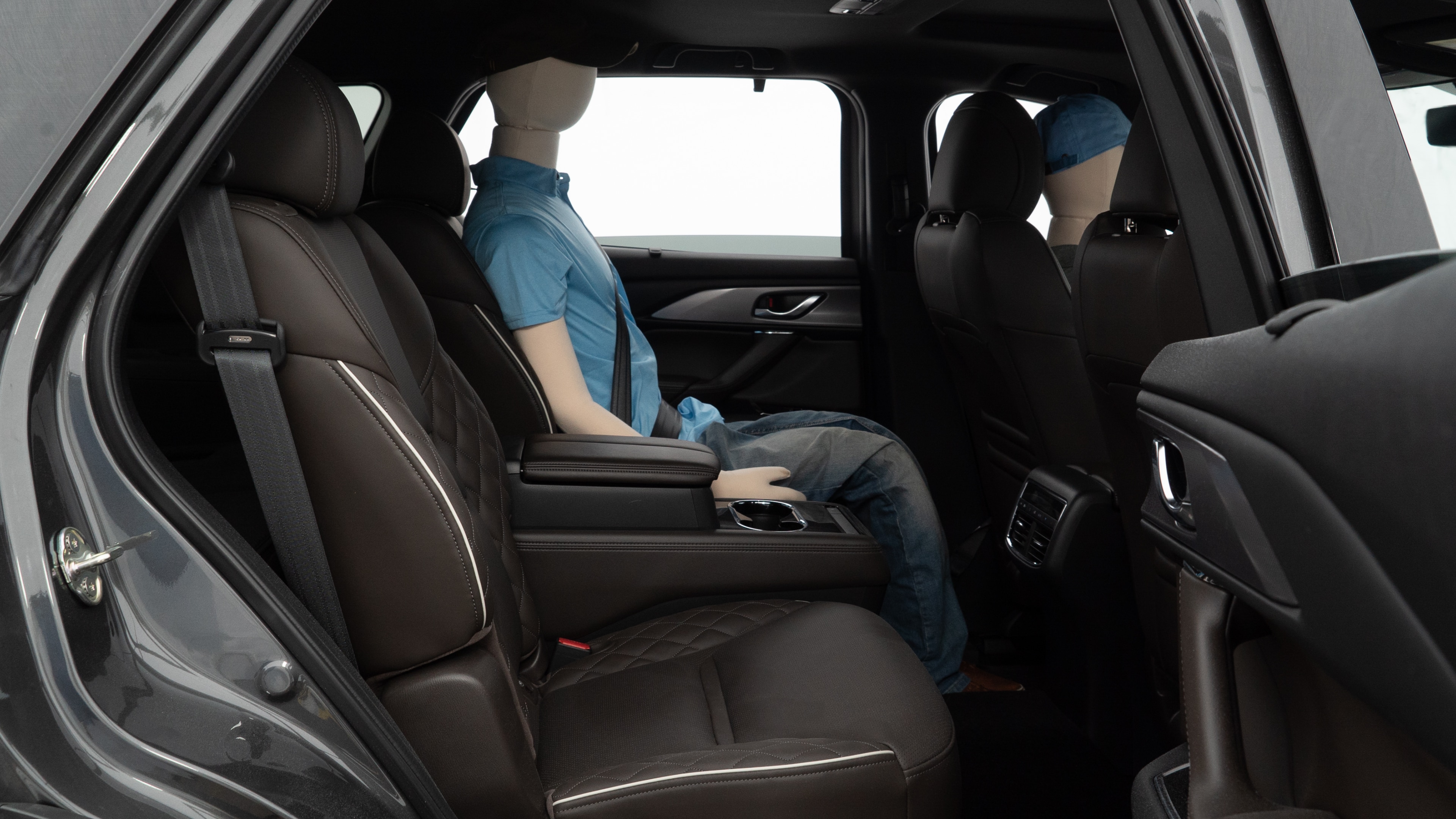 A series of second-row backseat photos is shown including one seating a baby seat and one seating a 6'1" mannequin.