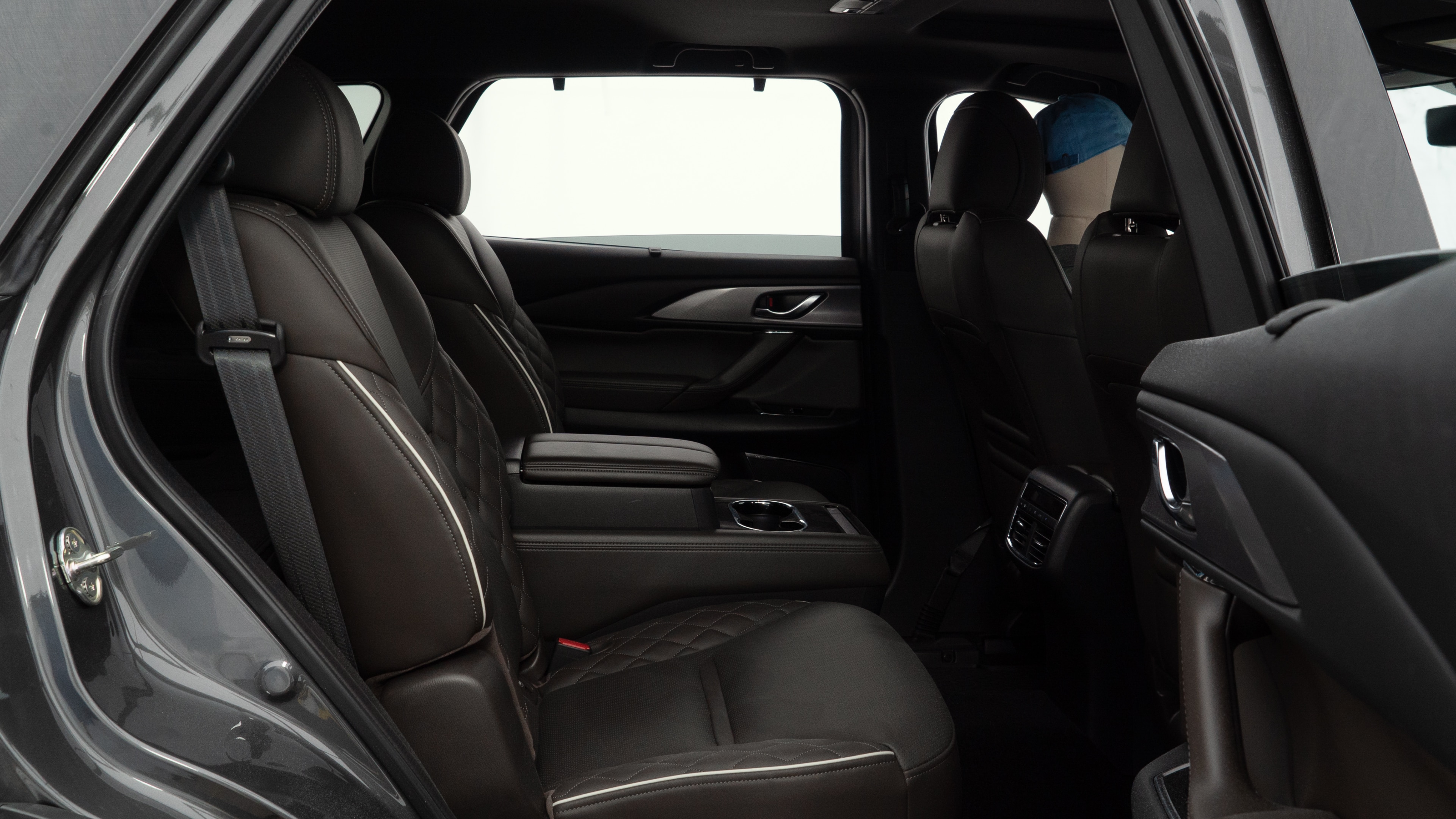 A series of second-row backseat photos is shown including one seating a baby seat and one seating a 6'1" mannequin.