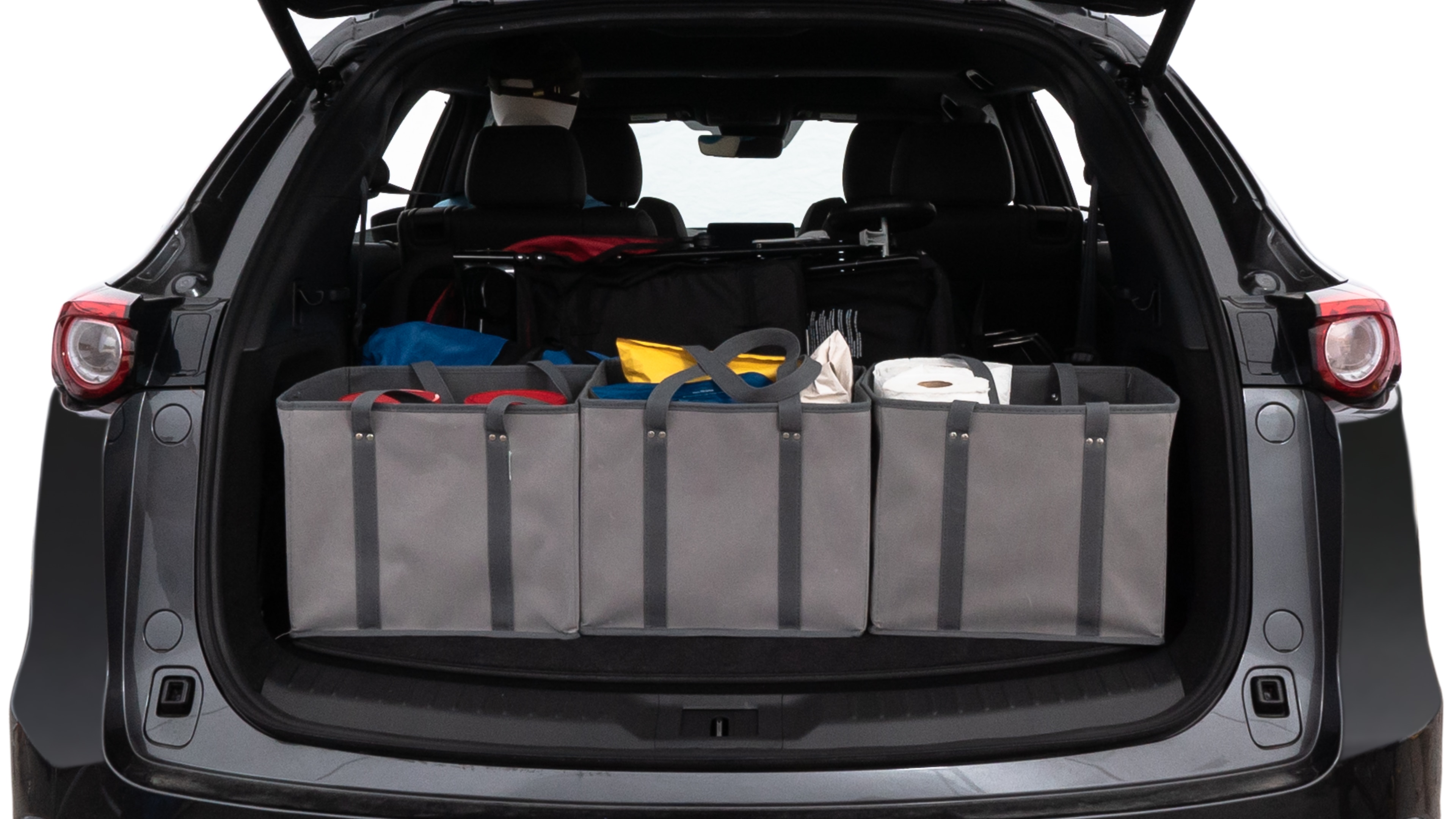 The trunk lid is open showing full view of the trunk. A baby stroller, three grocery carriers, two camping chairs in the carrying bag, and a set of golf clubs are placed inside.