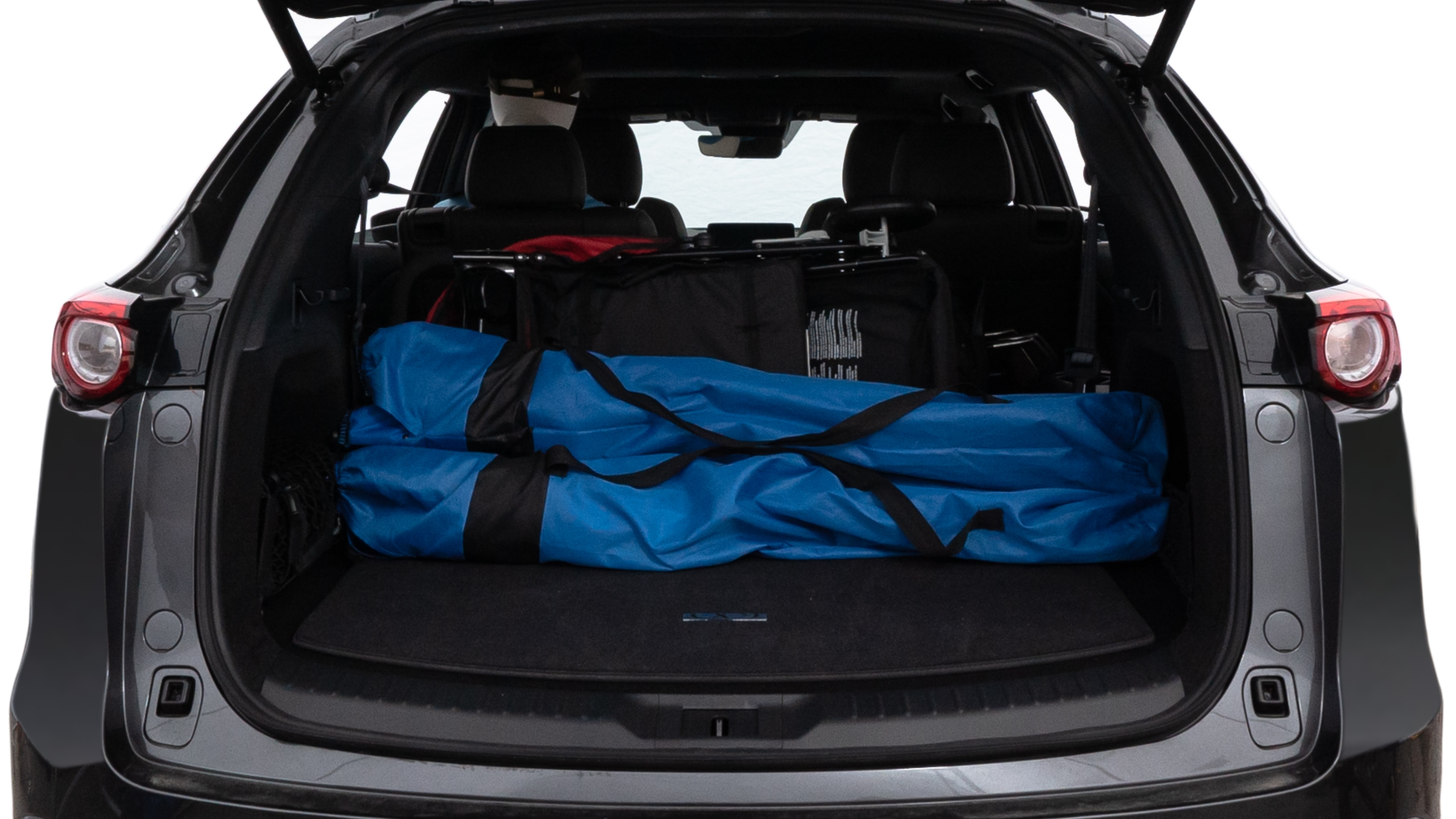 The trunk lid is open showing full view of the trunk. A baby stroller, three grocery carriers, two camping chairs in the carrying bag, and a set of golf clubs are placed inside.