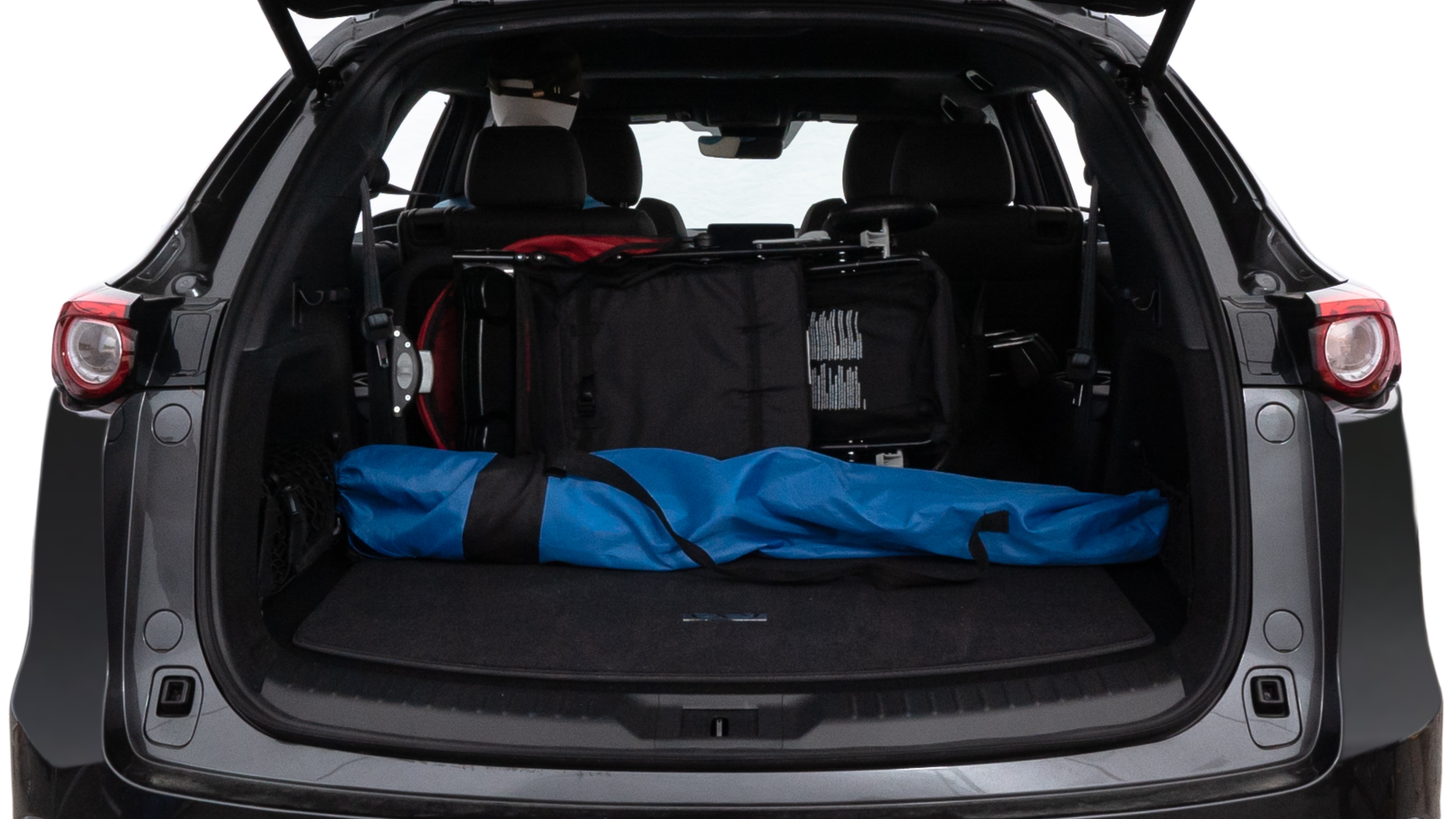 The trunk lid is open showing full view of the trunk. A baby stroller, three grocery carriers, two camping chairs in the carrying bag, and a set of golf clubs are placed inside.