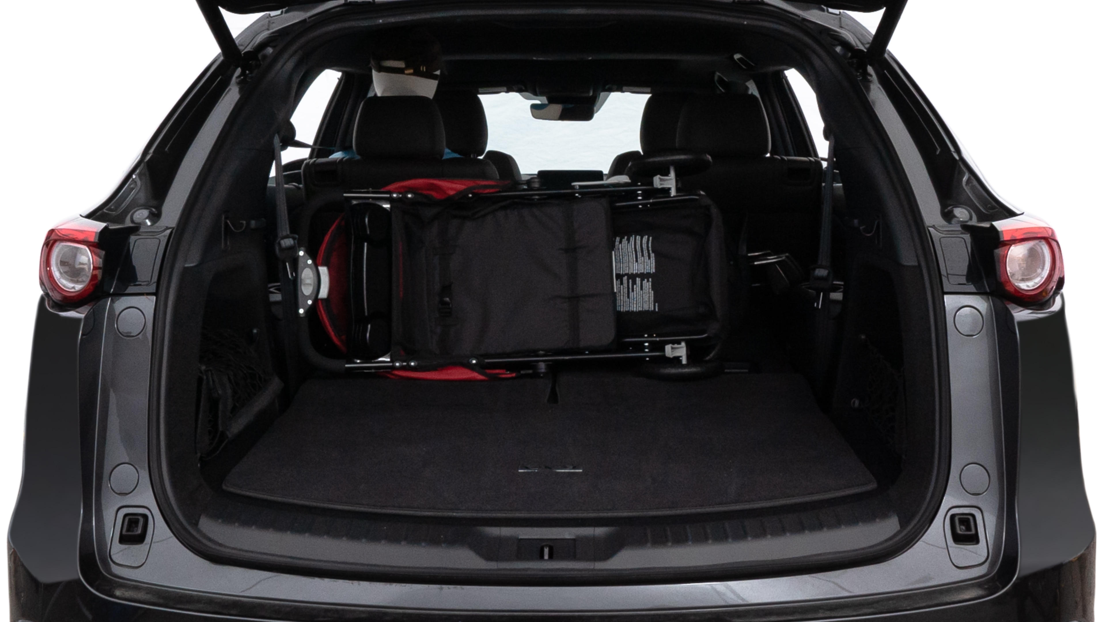 The trunk lid is open showing full view of the trunk. A baby stroller, three grocery carriers, two camping chairs in the carrying bag, and a set of golf clubs are placed inside.