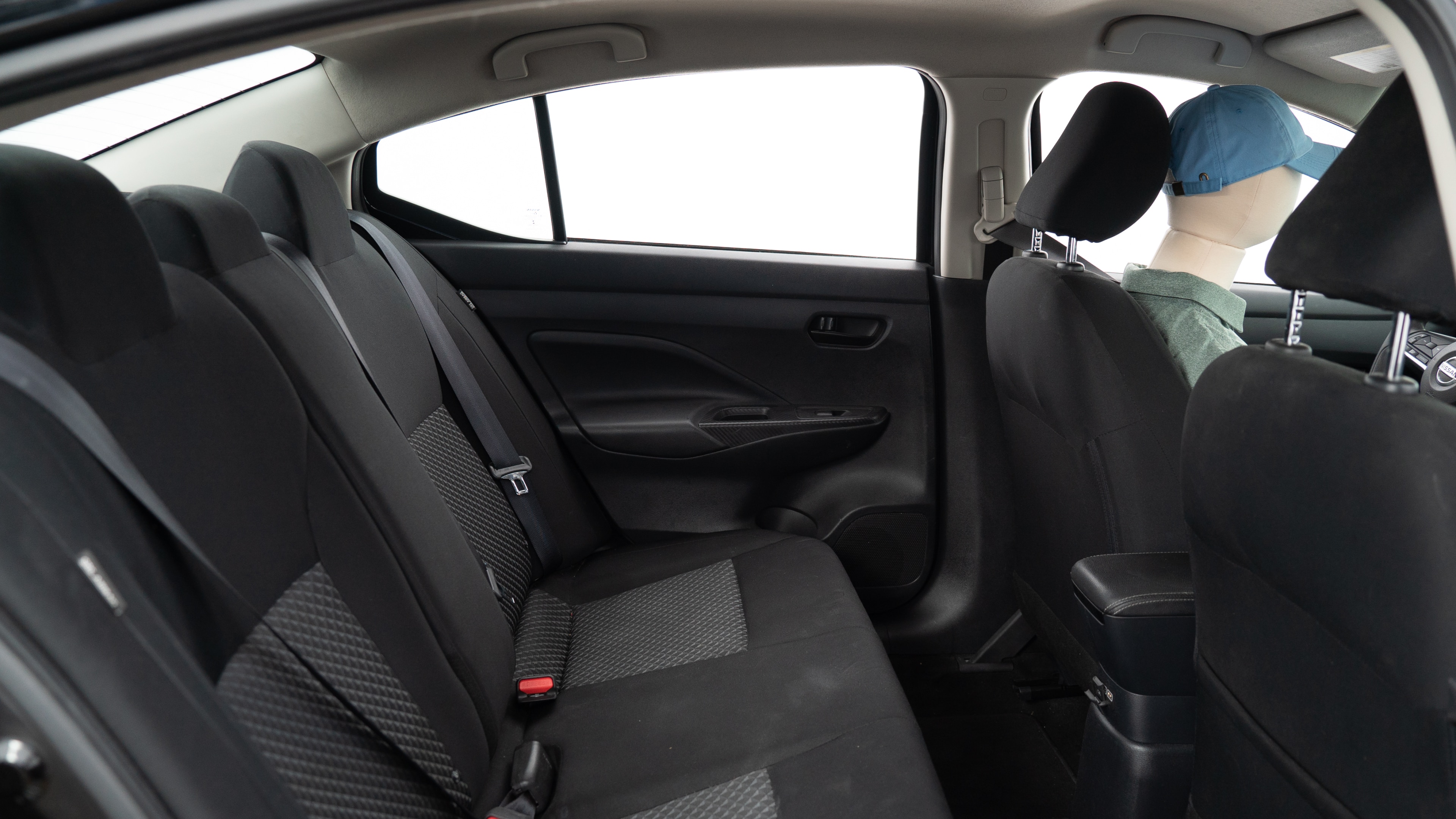 A series of second-row backseat photos is shown including one seating a baby seat, a dog and one seating a 6'1" mannequin.