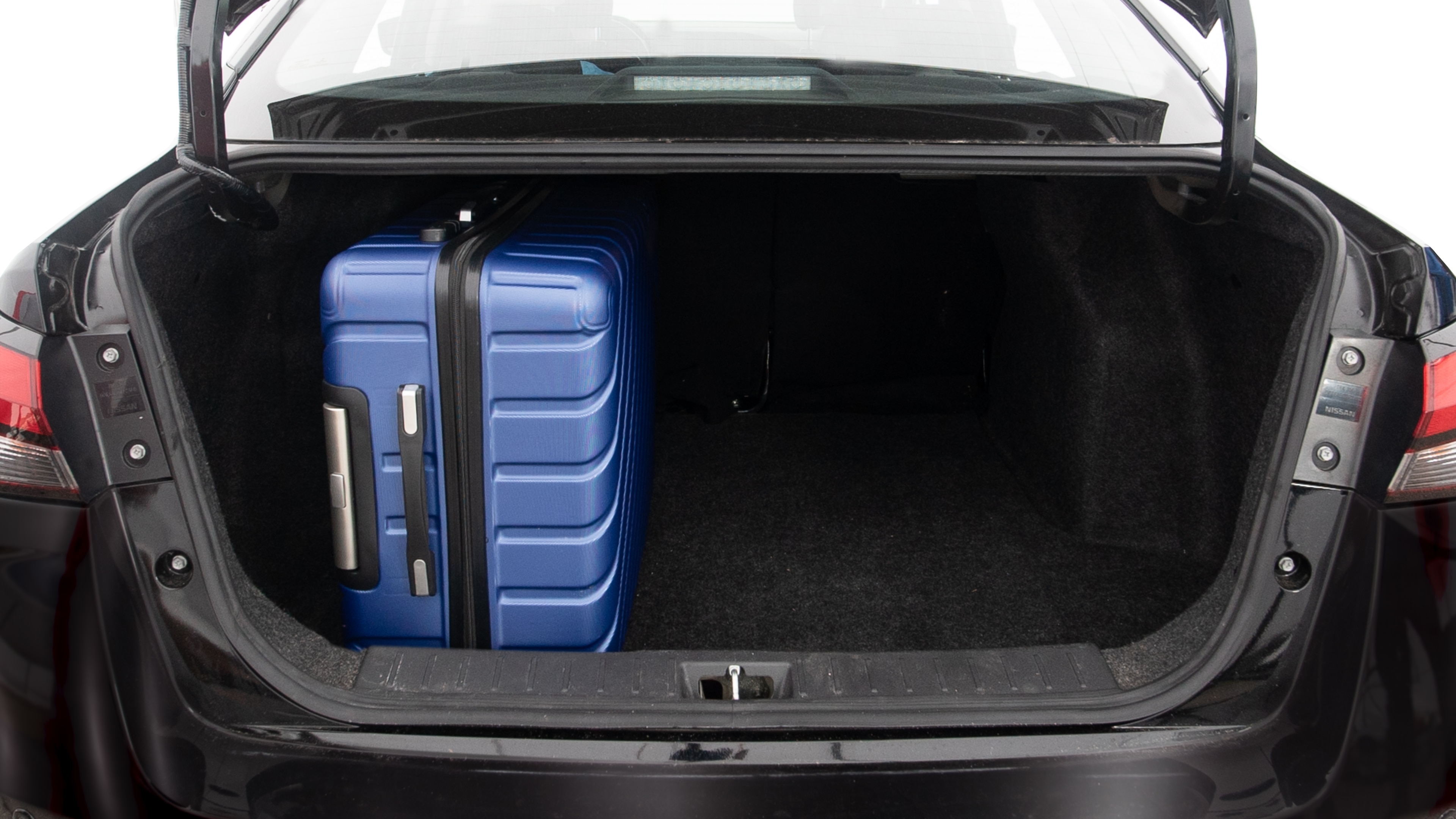 The trunk lid is open, showing full view of the trunk space. One extra large, two large and one small suitcases are placed inside.