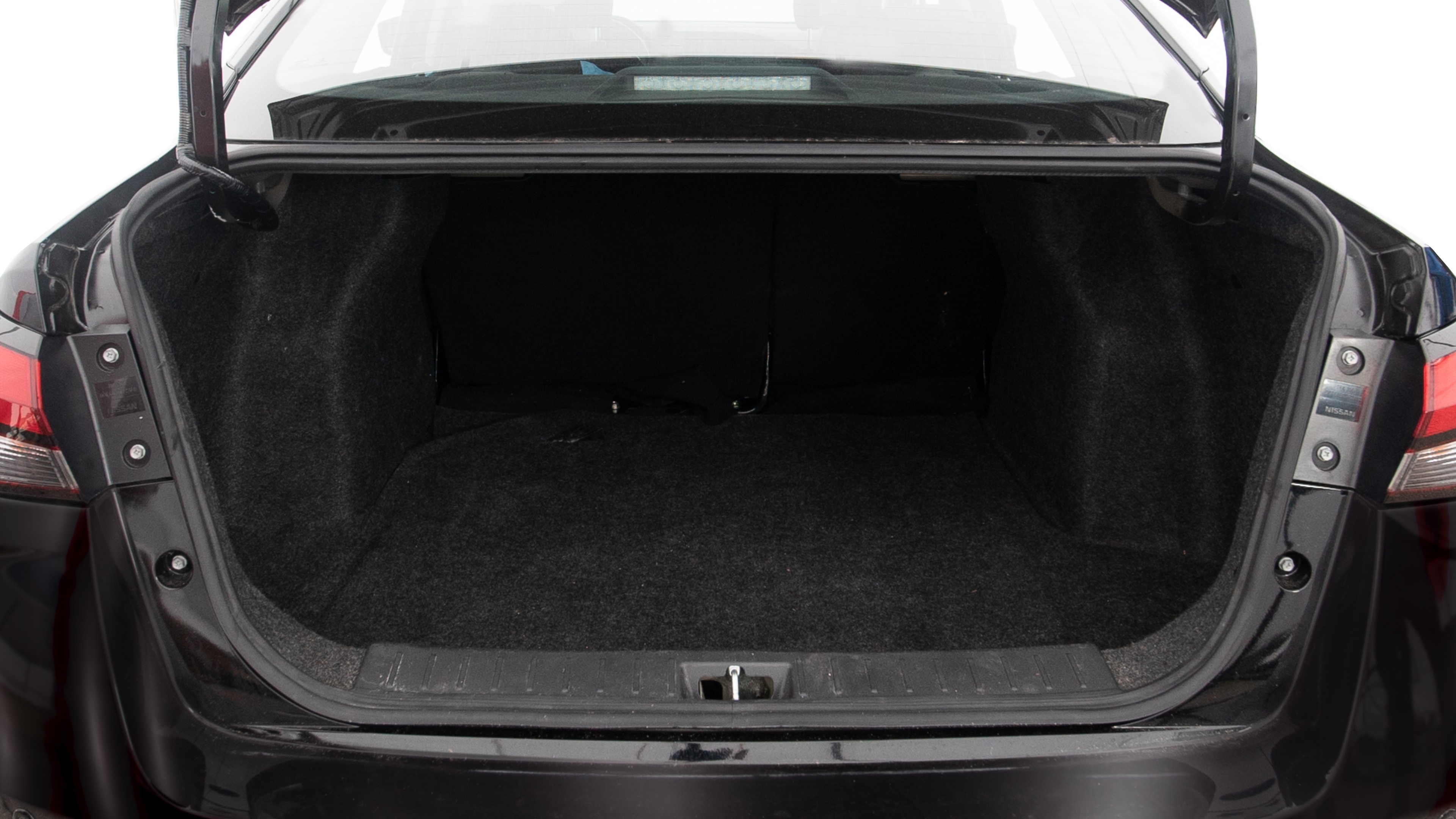 The trunk lid is open, showing full view of the trunk space. One extra large, two large and one small suitcases are placed inside.
