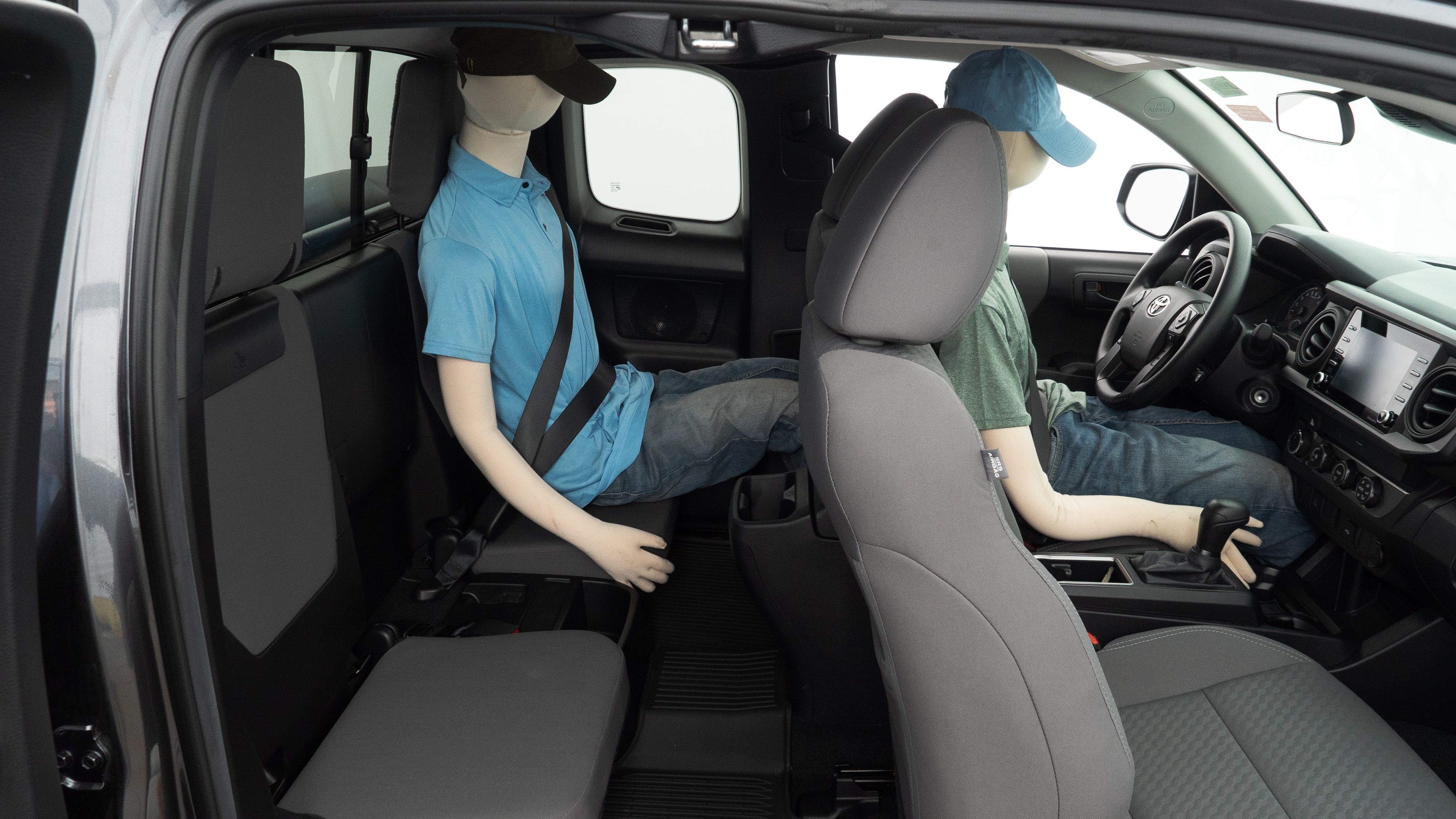 A series of second-row backseat photos is shown including one seating a baby seat and one seating a 6'1" mannequin.