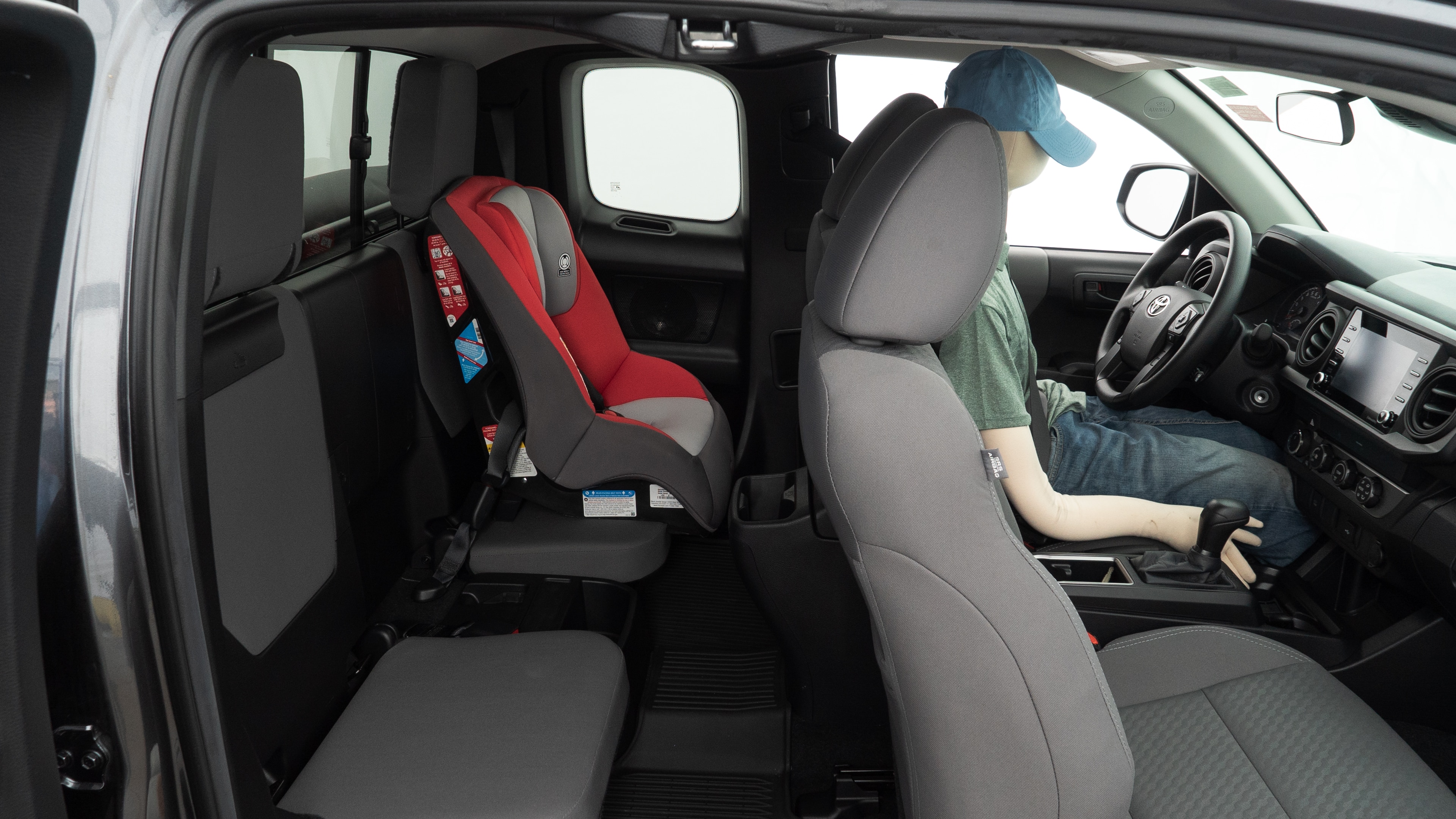 A series of second-row backseat photos is shown including one seating a baby seat and one seating a 6'1" mannequin.