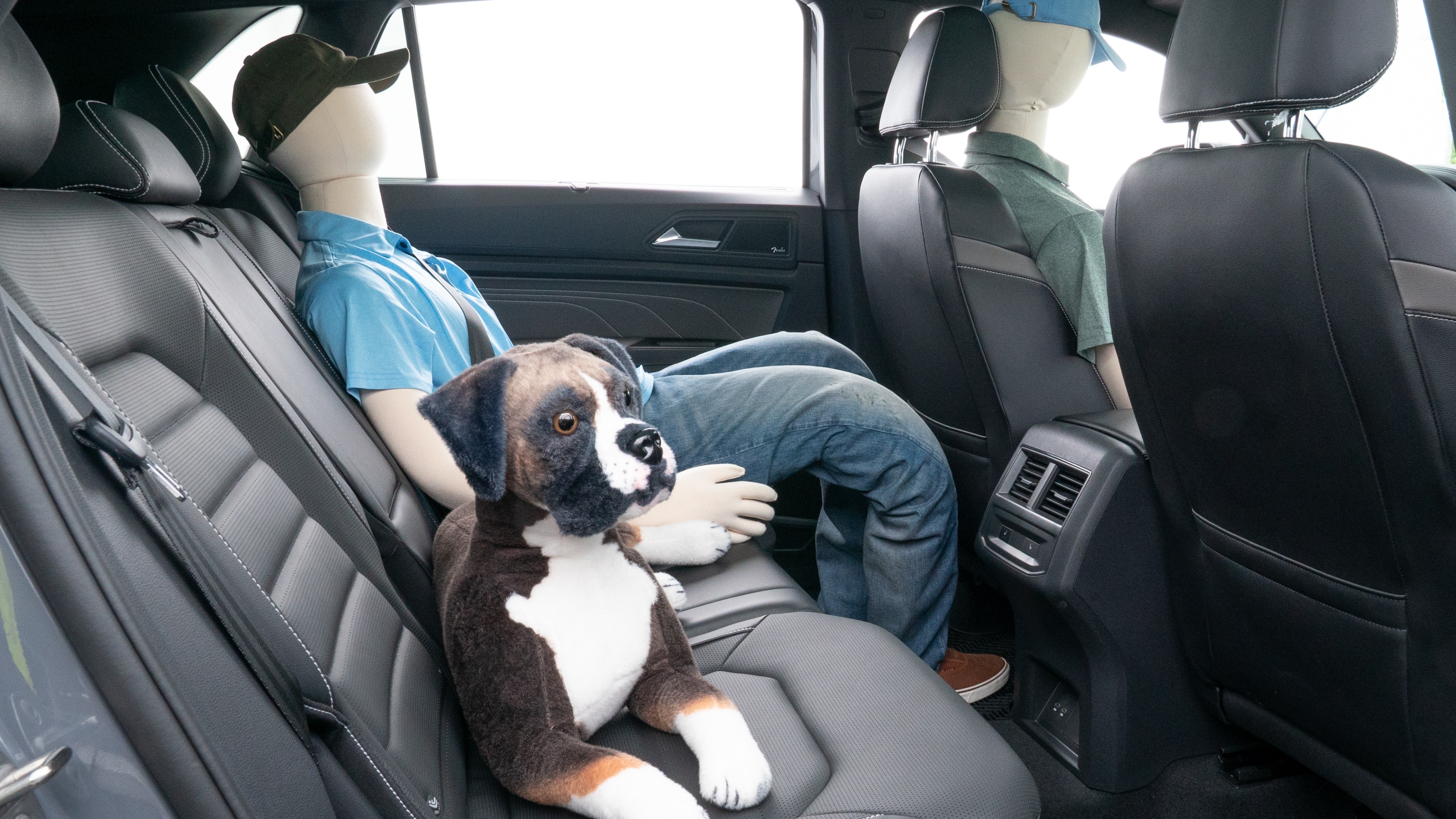 A series of second-row backseat photos is shown including one seating a baby seat and one seating a 6'1" mannequin.