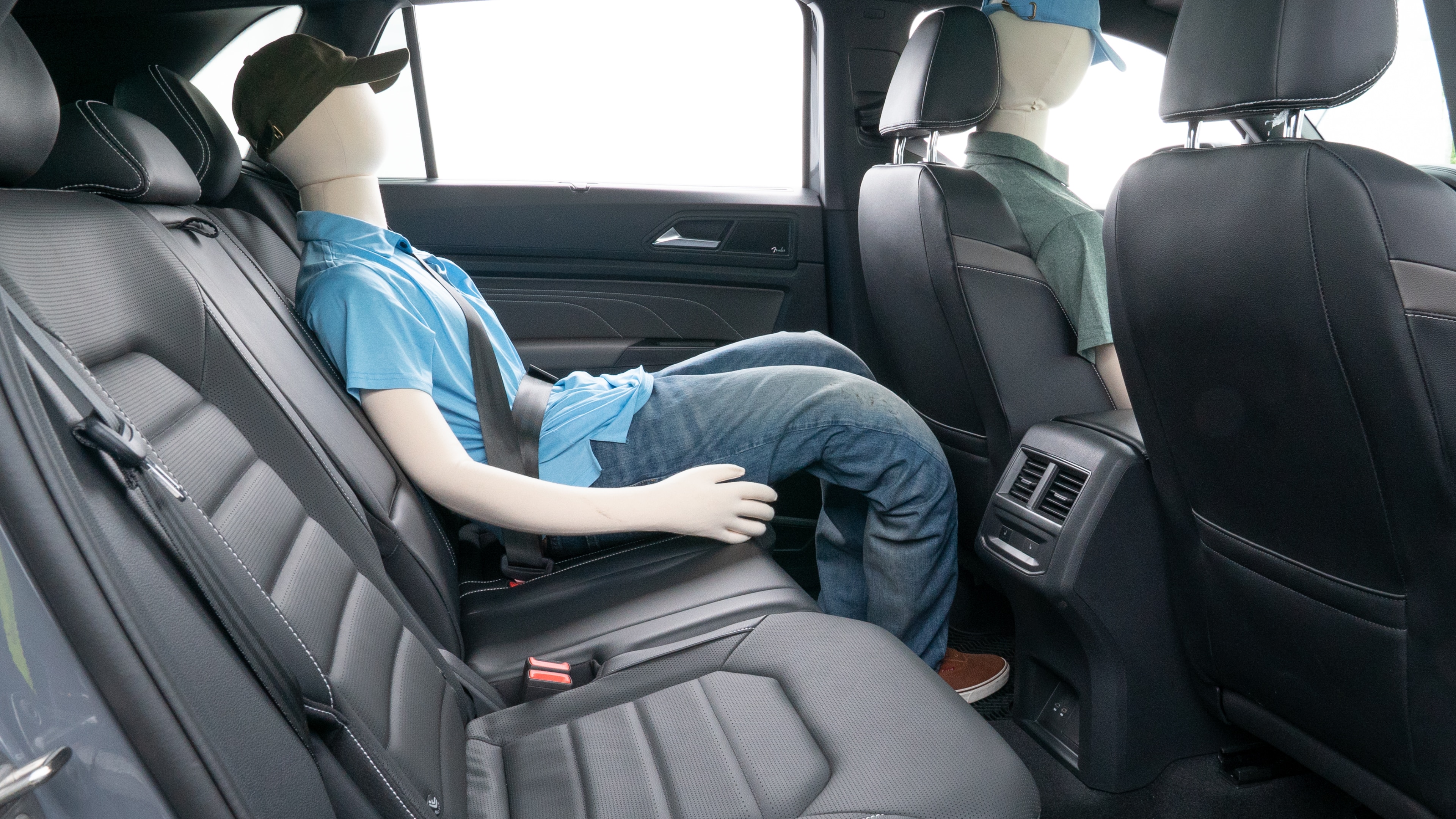 A series of second-row backseat photos is shown including one seating a baby seat and one seating a 6'1" mannequin.