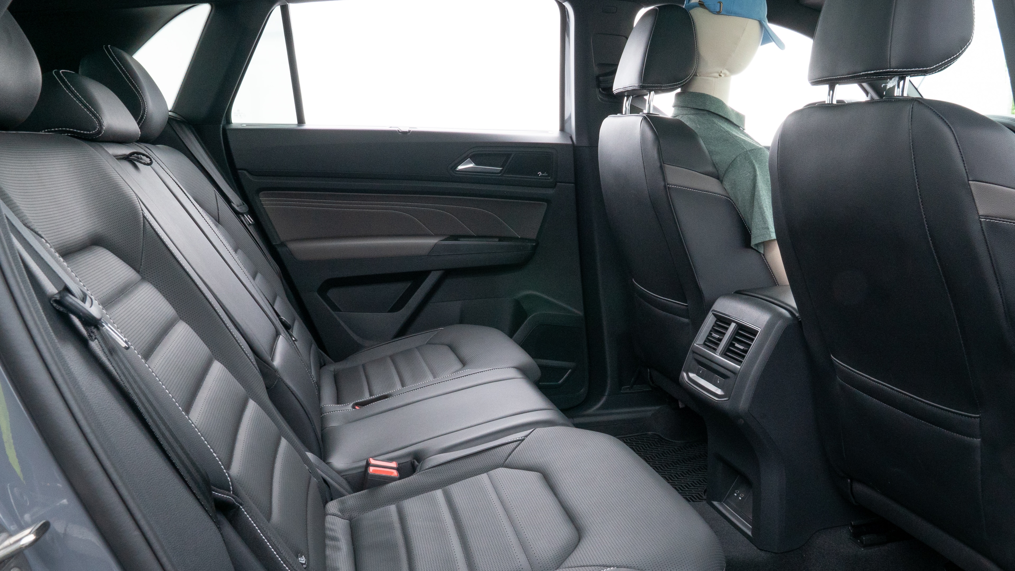 A series of second-row backseat photos is shown including one seating a baby seat and one seating a 6'1" mannequin.